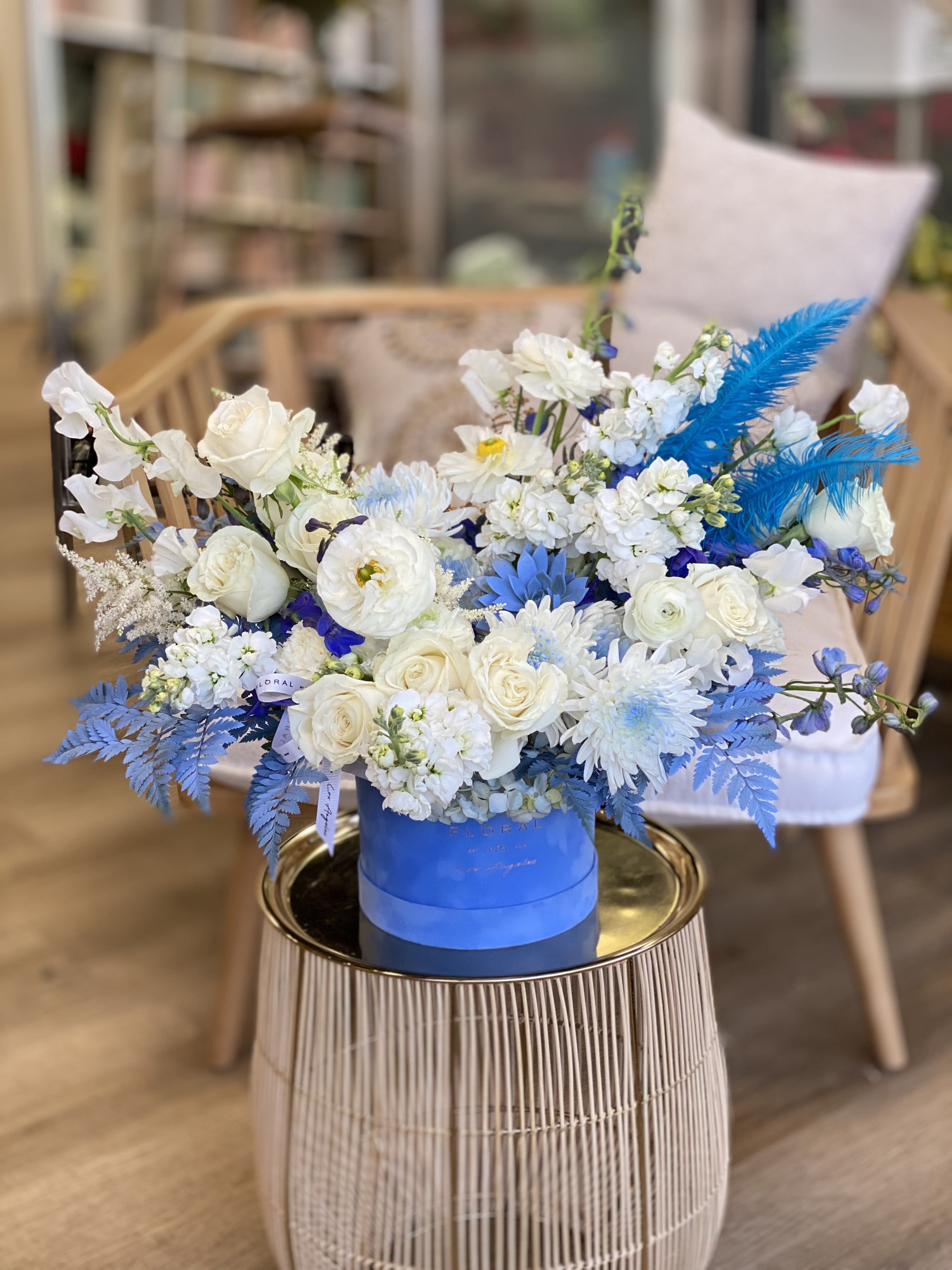 No. 222 - Blue Feathers - This beautiful blue and white arrangement made with Roses, Fern, stock, succulent and more flowers to complete composition   Available in one size only
