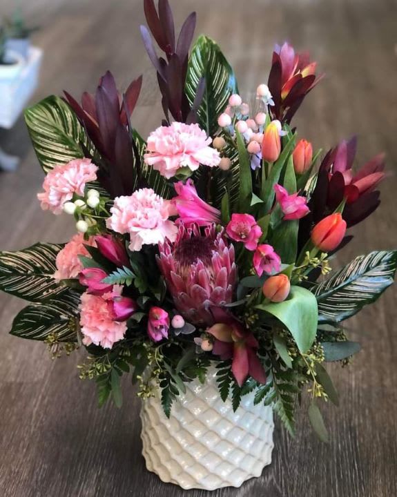 beautiful variety of bright colored flowers. - this design come is a beautiful mother of pearl vase that she can use again and again. will add a wonderful touch to her boutiques.