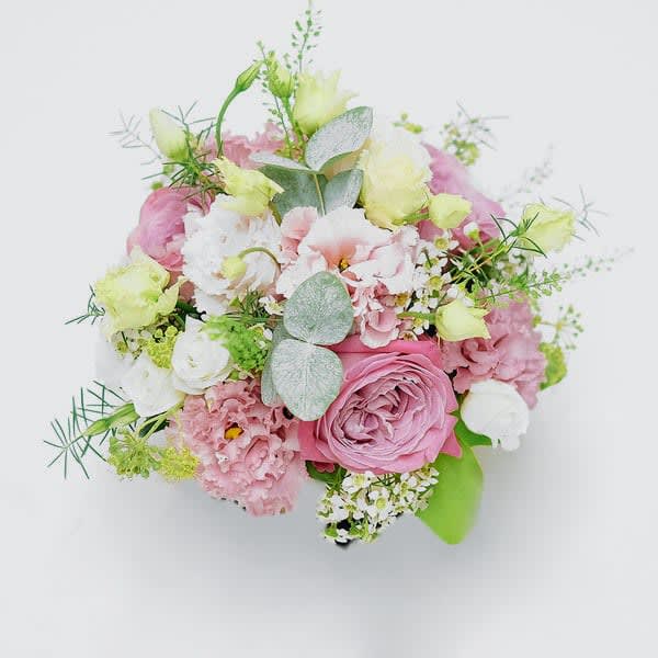 Pink Champagne - A Delightful oasis with an option for a vase or just as a hand tied bundle. With pink lisianthus, white spray roses and pink roses. 