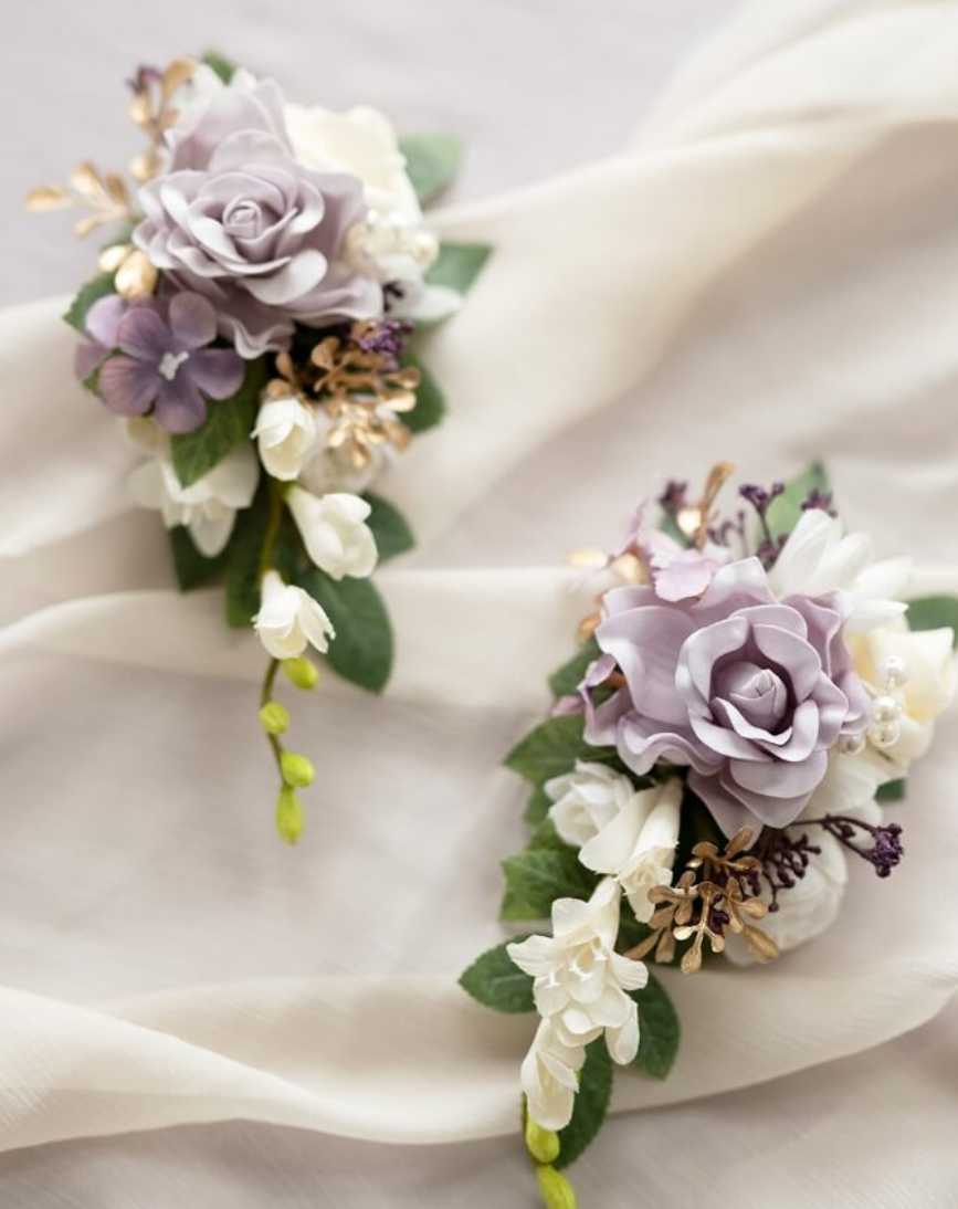 Corsage  - This stunning prom corsage brings a touch of elegance to any formal attire. Designed with a lovely flower, such as an orchid or rose, and complemented by soft greenery and a coordinating ribbon, it's an essential accessory for your special evening. Wear it on your wrist to add a sophisticated flourish to your prom ensemble.