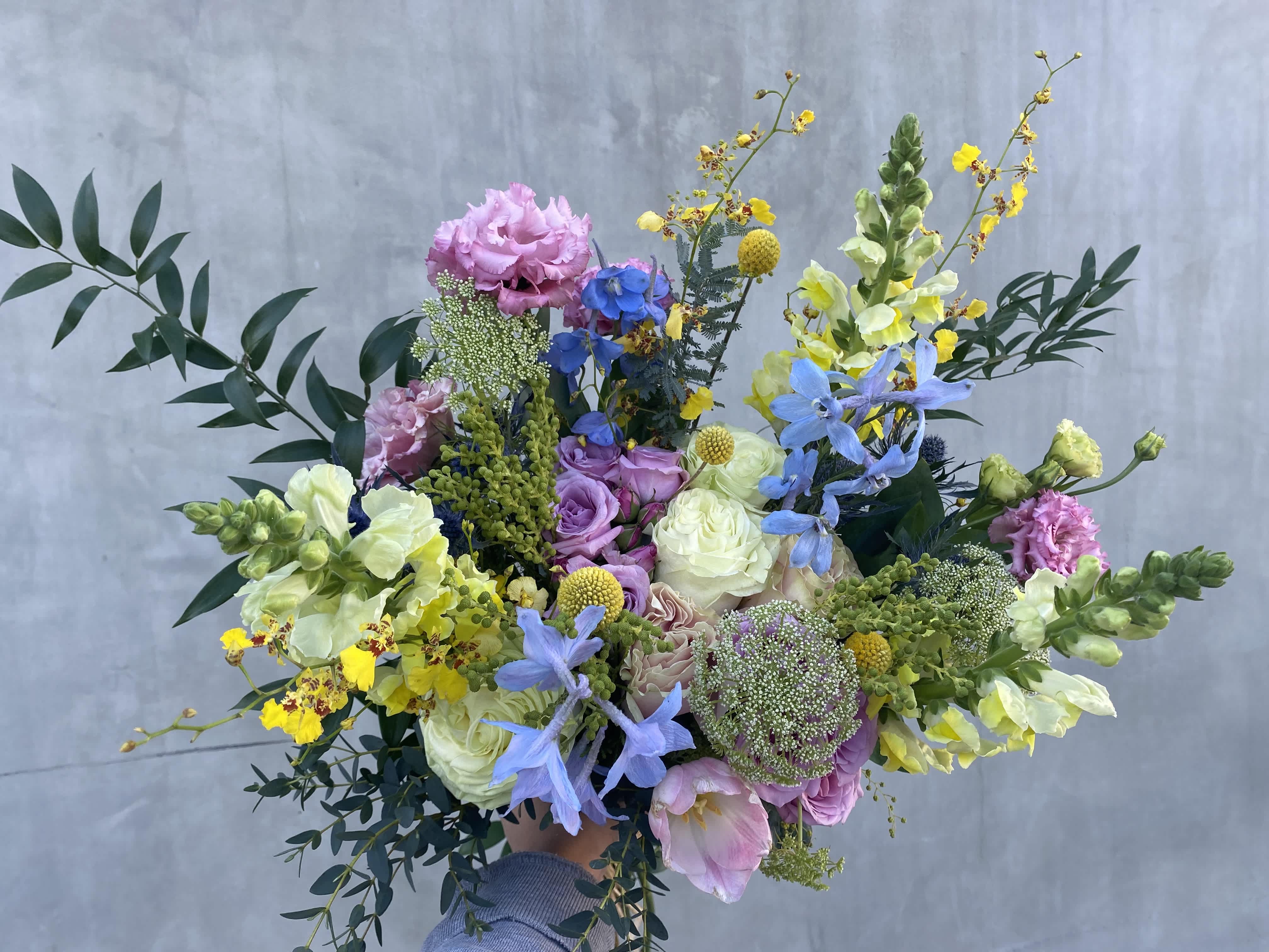 Wild Floral Fantasy Wild Floral Fantasy - Beautiful bouquet with a mixture of wild flowers hand wrapped in brown paper. Note: The picture shown above is a premium.