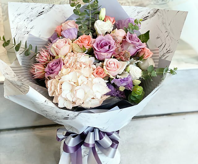 Meadows of Love Wrapped Bouquet  - Meadows of Love Wrapped Bouquet. Assorted fresh flowers including hydrangea, roses and other seasonal favorites.  Our loose bunches do NOT include vases.  Paper and bow color may vary.