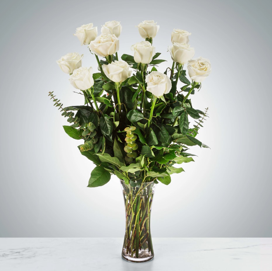 A Dozen Long Stem White Roses by BloomNation™ - A dozen white roses, nestled in eucalyptus and other greenery are a classic gift! Perfect for any celebration.