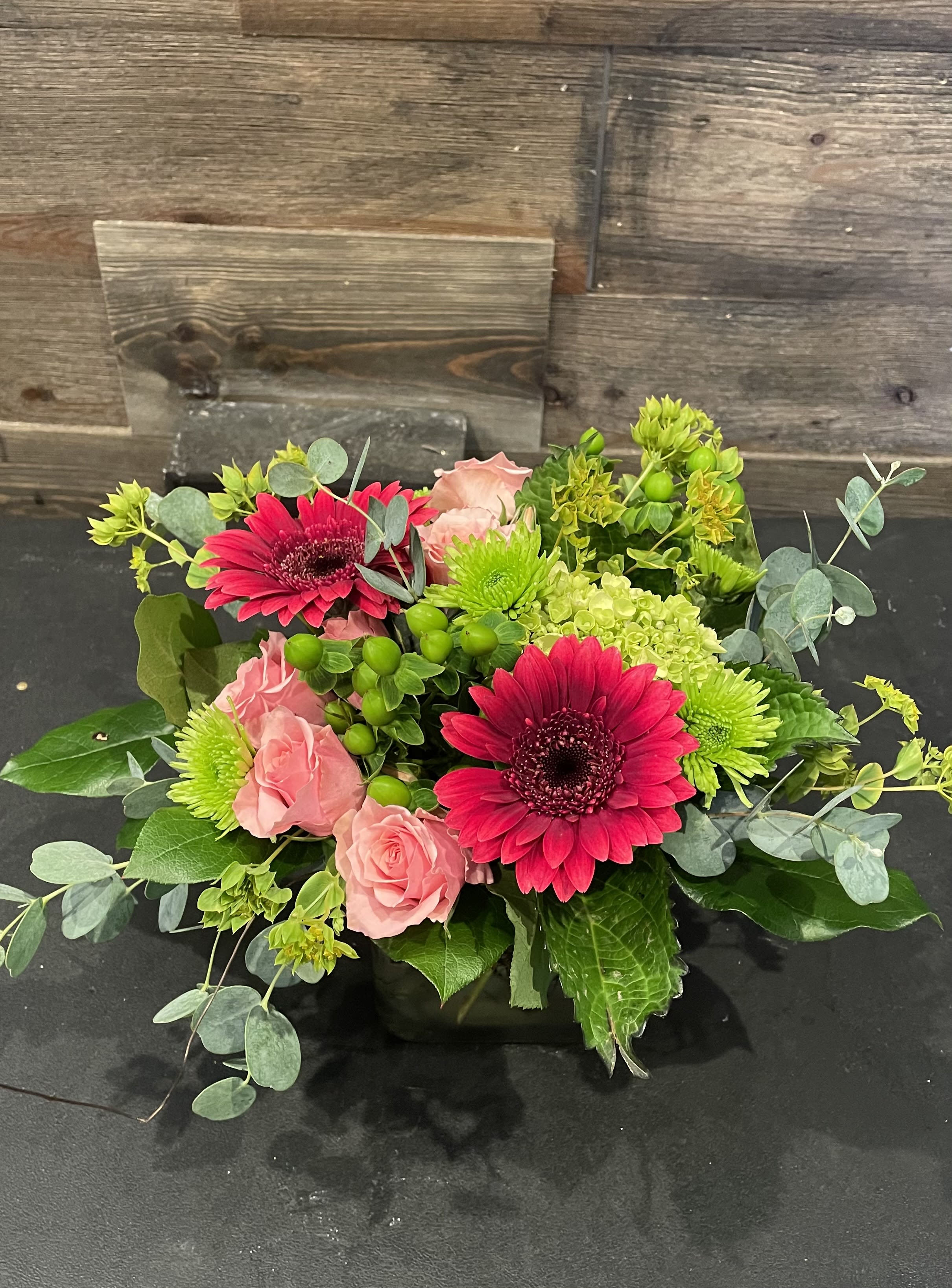 Cherry Limeade - In a 4&quot; square vase, and arrangement of gerbera daisies, spray roses, hydrangea, hypericum berries, kemit poms and a mix of greenery. Approx. 8&quot; Tall x 10&quot; Wide 