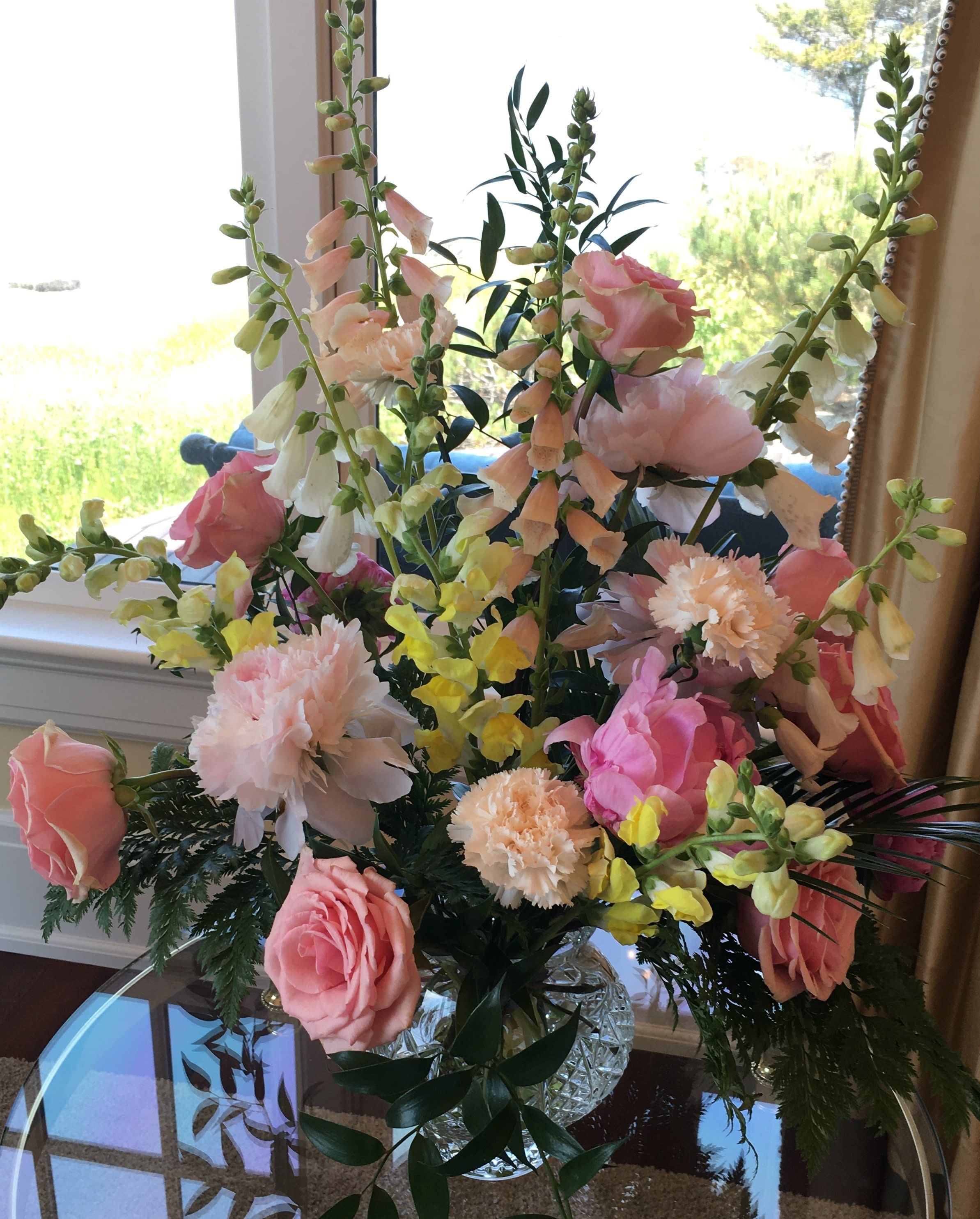 Touch of Elegance  - Tall vase arrangement with foxglove, peony, carnations, and roses in a low glass vase. 