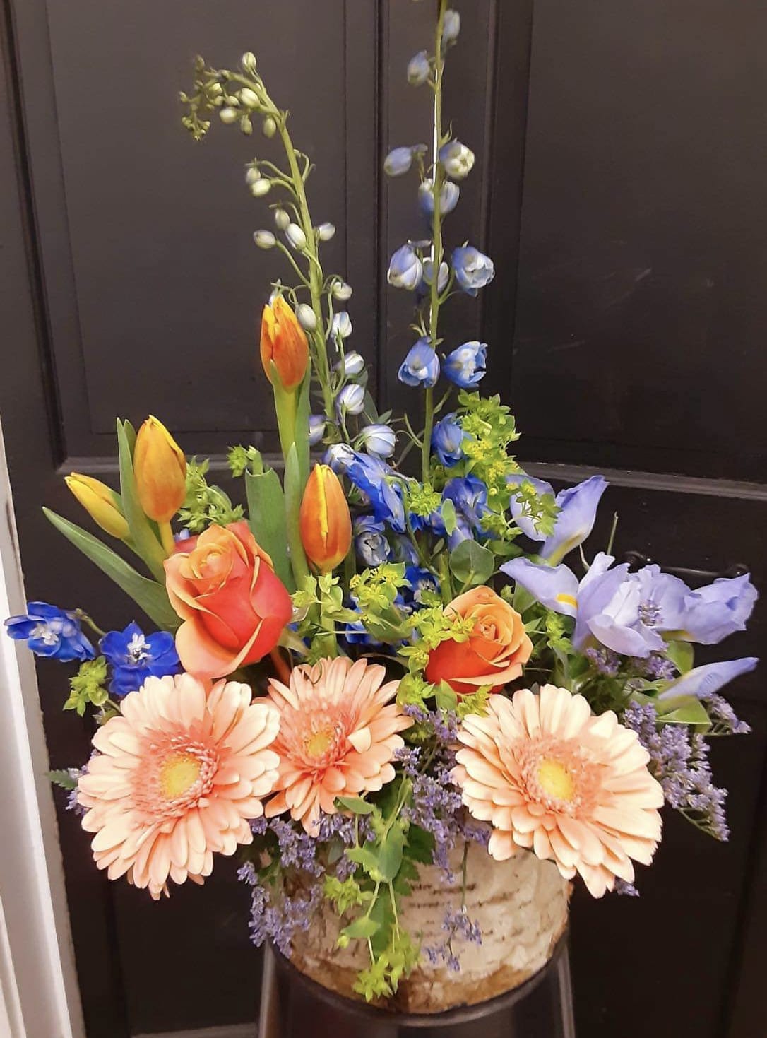 Peach sunset - Birch vase arrangement with delphinium, tulips, gerberas, and iris. 