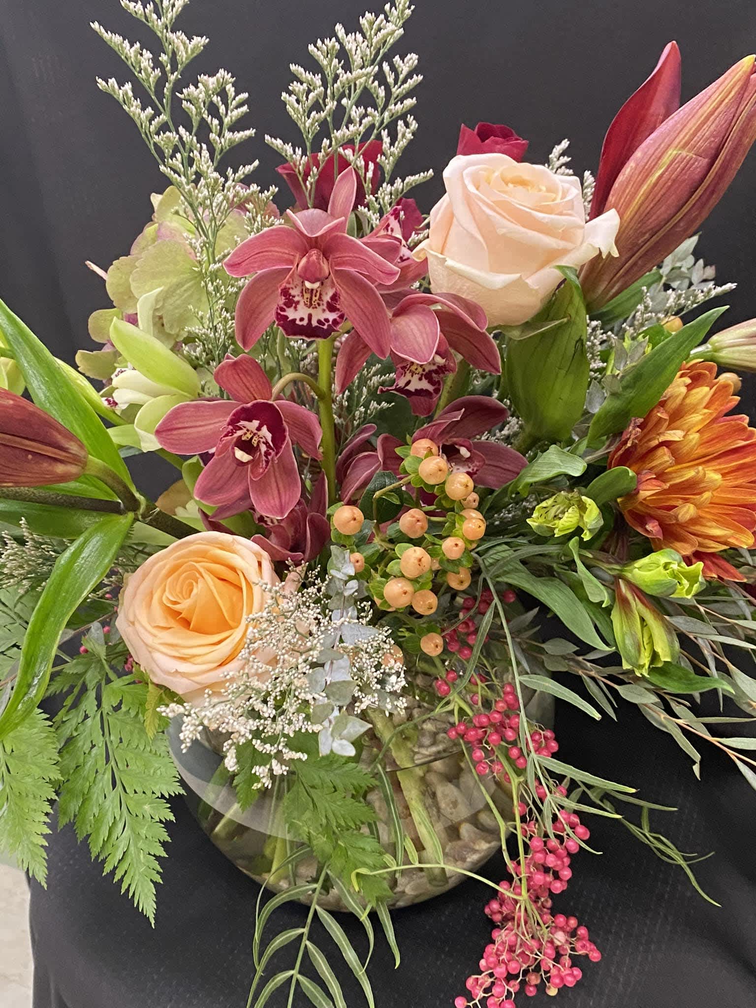 Summer Garden - Bubble bowl arrangement with orchids, roses, and lilies. 