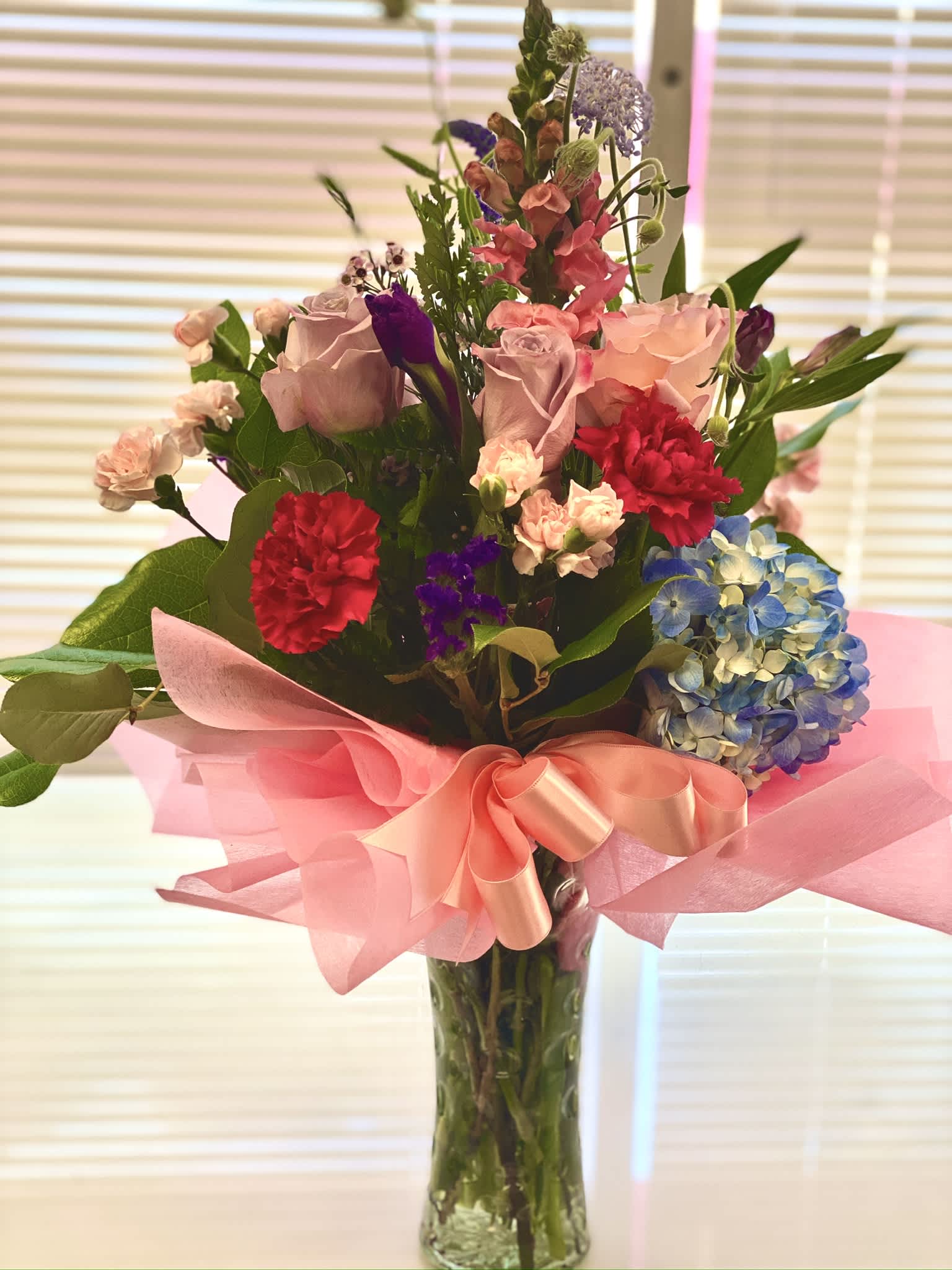 Beautiful Summer  - Mixed floral arrangement with roses, Hydrengea and a mix oin season blooms, draped with specialty water resistant tissue