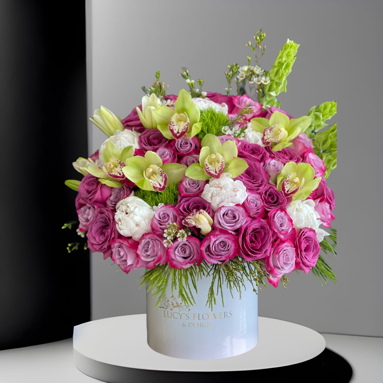 Enchanted Love Enchanted Love - This beautiful lavender arrangement is guaranteed to brighten someone's day. Enchanted Love is perfect for someone's birthday or for anyone that needs cheering up. Arrangement Includes: -Fresh cut lavender roses, peonies, orchids and other flowers -Lucy's Flowers & Design Medium box (9.75" Dia. x 9.25" H) -Custom Greeting Card -Care Instructions