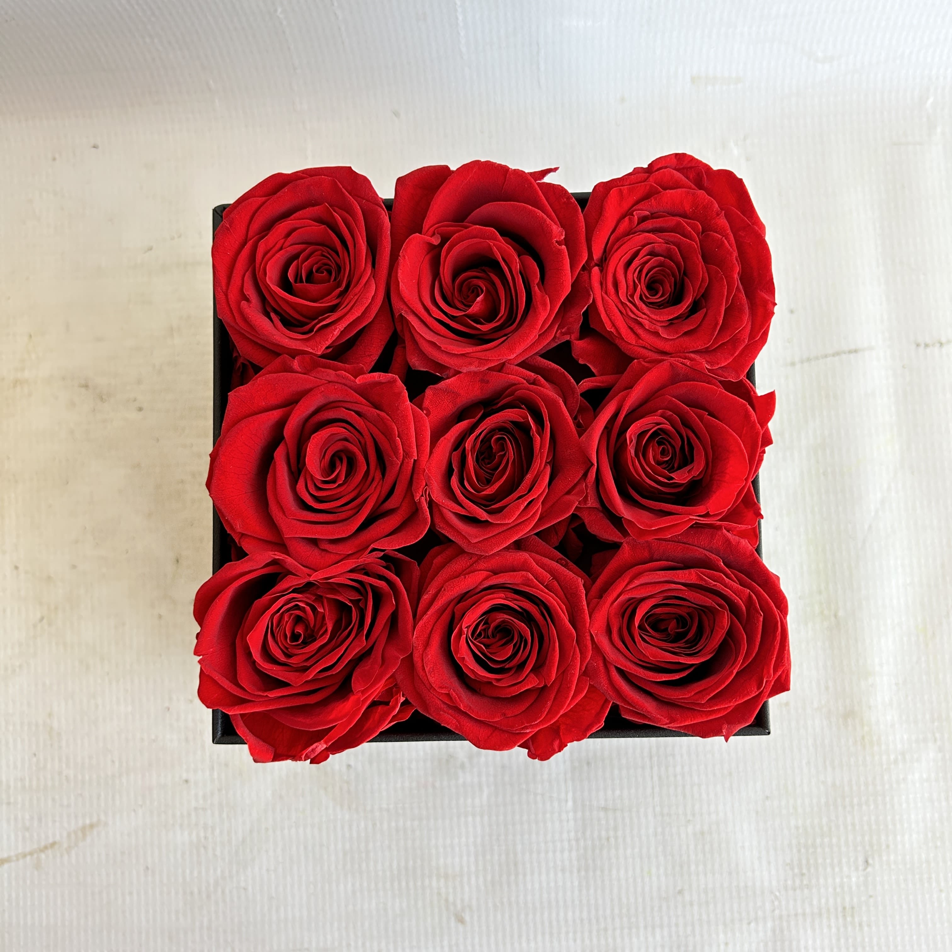 Permanent Roses Box - Elevate the art of gifting with our Permanent Roses Box. Encased in a square-shaped box, these eternal roses radiate love and passion, forever. Meticulously preserved to maintain their beauty, they require no upkeep. A timeless symbol of affection that lasts a lifetime.