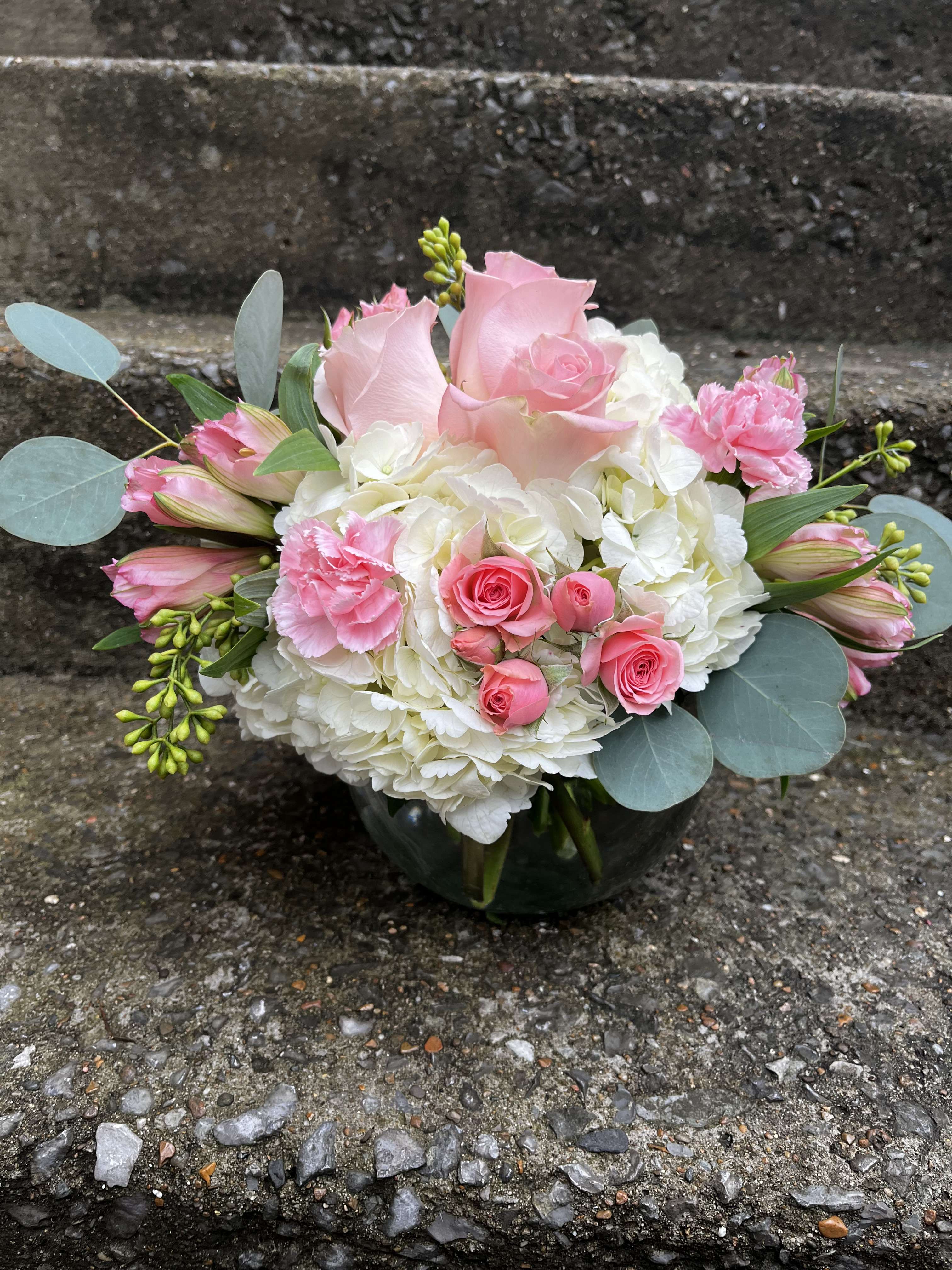 Pink Pastel  - This arrangement has white hydrangea, pink roses, pink spray, roses, mini carnations, pink alstroemeria, and seeded eucalyptus.