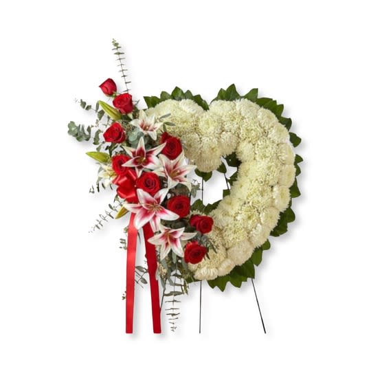 Standing Heart Spray: Red &amp; White - The passing of someone we love deeply requires a special tribute. Our open heart standing arrangement of fresh white blooms, accented by red roses and Stargazer lilies cascading down one side and adorned with a red satin ribbon, will help you express the devotion and sympathy in your heart.