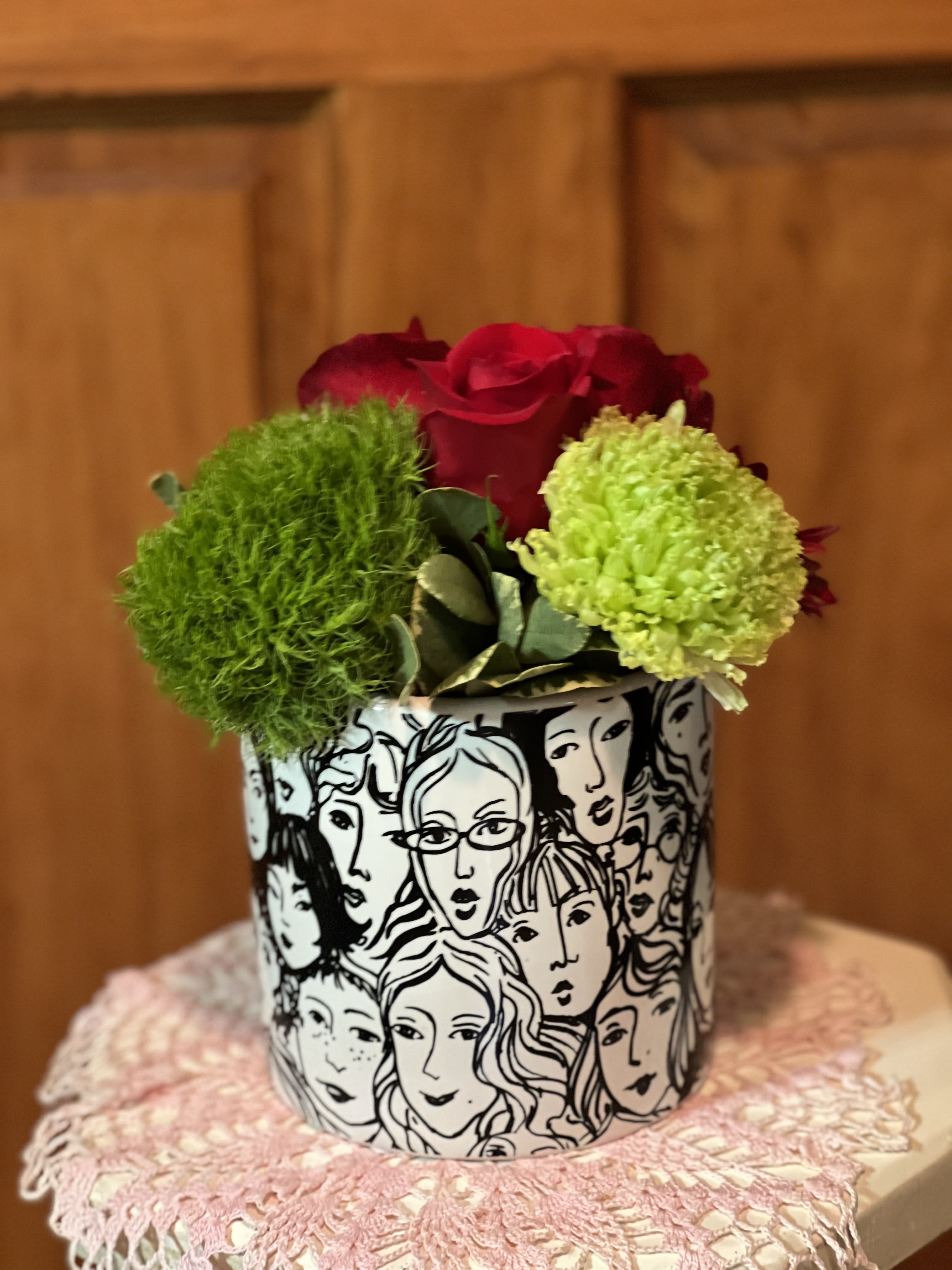 MOM -  MOM is a wonderful statement to the many faces of MOM. The faces of the women could represent the strength, diversity, and beauty of women all over the world. This round ceramic container could be seen as a tribute to the beauty and grace of women. Filled with an assortment of beautiful blooms. 