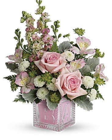 Teleflora's Bundle Of Joy Bouquet Teleflora's Bundle Of Joy Bouquet - Welcome the new addition with a charming glass baby block keepsake bursting with a sweet pink bouquet of roses mums and delphinium.