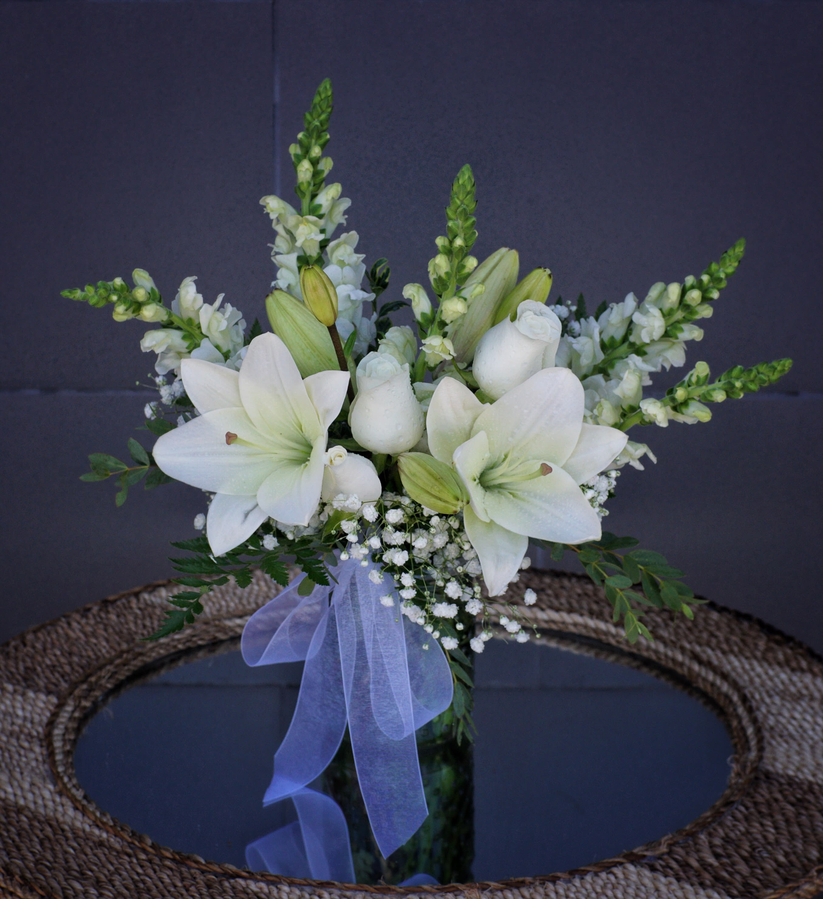 Pure White - Pure white including rose, lily, snapdragon and accents in a glass vase.