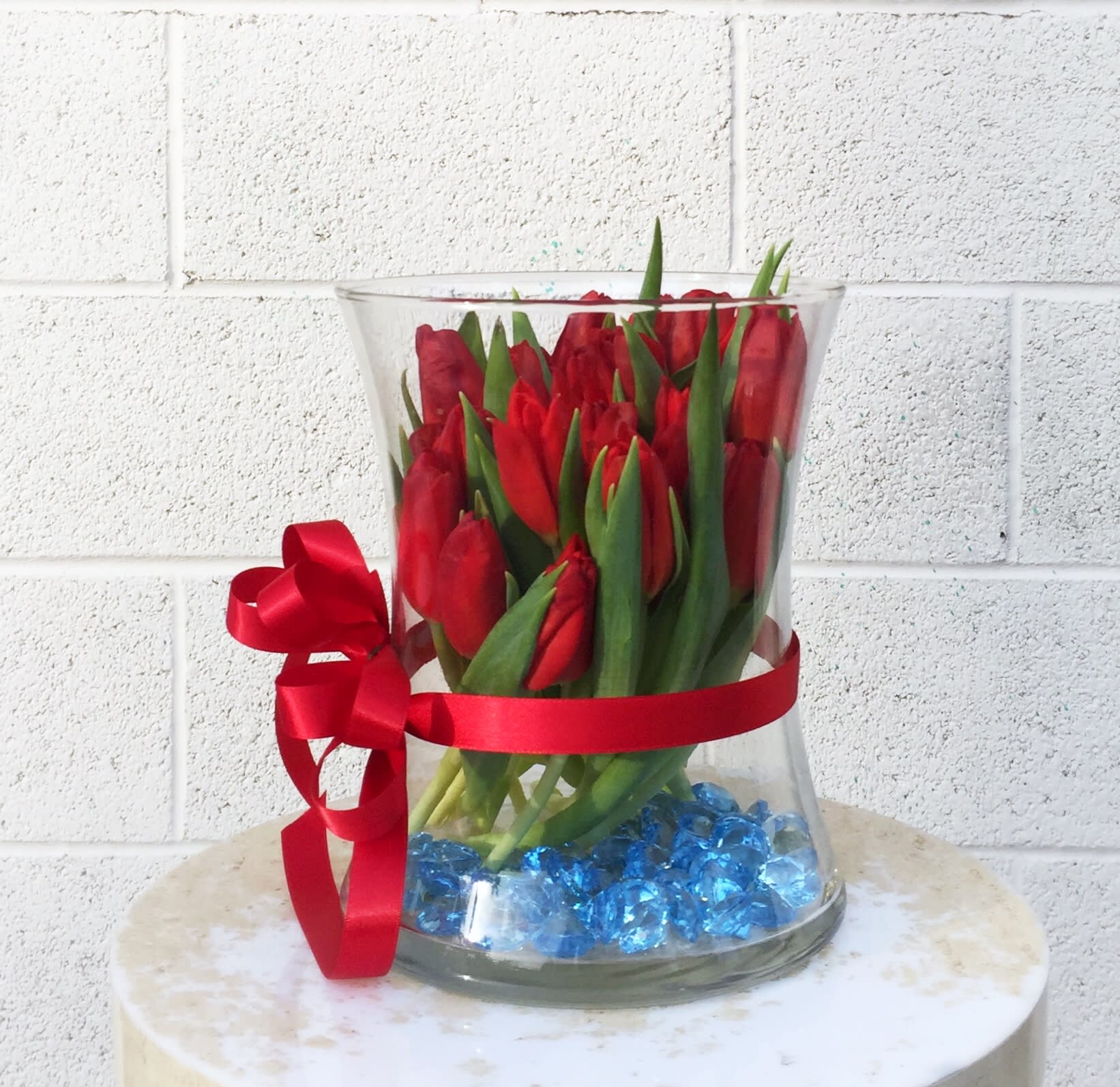 Vision of Love - Pretty design with tulips and accents in a nice glass vase. STANDARD AS SHOWN: 20 TULIPS DELUXE: 20 TULIPS + 6 ROSES PREMIUM: 20 TULIPS + 12 ROSES