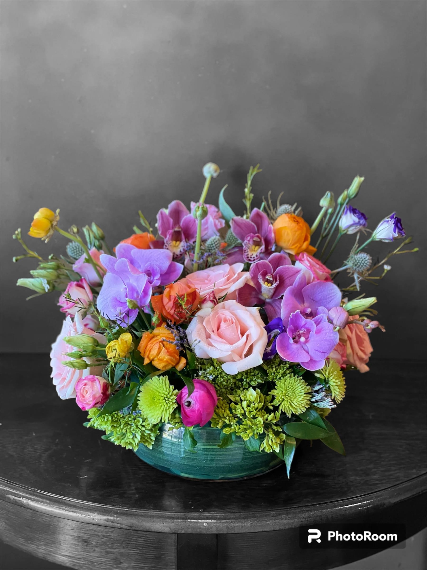 Sweet Dream Sweet Dream - At once radiant and reverent, this colorful bouquet of roses, Phalaenopsis orchids, and Lisianthus is beautifully arranged in a round vase - a touching tribute to a bright life and your unending support.