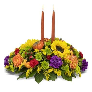 Bountiful Blooms Centerpiece Bountiful Blooms Centerpiece - Expressive sunflowers are blended with carnations, athos poms, solidago, hypericum and roses to create a bountiful, and beautiful, botanical celebration in a designer dish container with faux gourds and a tapered candle. Ideal for every Fall and holiday table! Arrangement Height 14", Length 19"