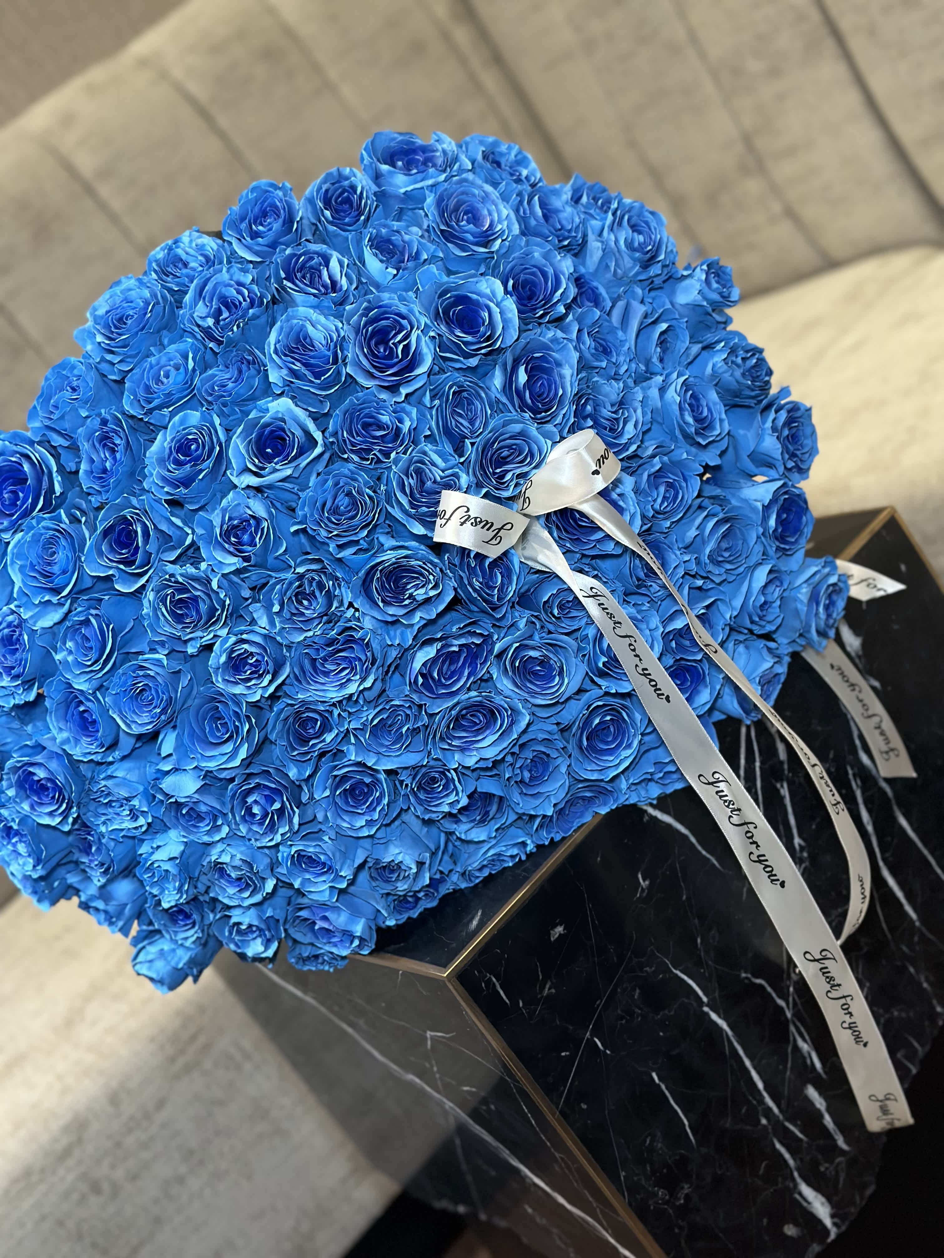 Ocean Bouquet Ocean Bouquet - A bouquet of 100 azure roses, a cascade of serenity and grace, adorned with a satin ribbon, gently whispers tales of tranquility and elegance. Each bloom, like a fragment of the sky, exudes a timeless beauty that captures the essence of peaceful moments. The ribbon, a delicate accent, adds a touch of sophistication to the ensemble, weaving through the blooms like a gentle breeze. Together, they form a mesmerizing tableau, a symphony of blue hues that evokes a sense of calm and serenity, enveloping the senses in a dreamlike embrace.