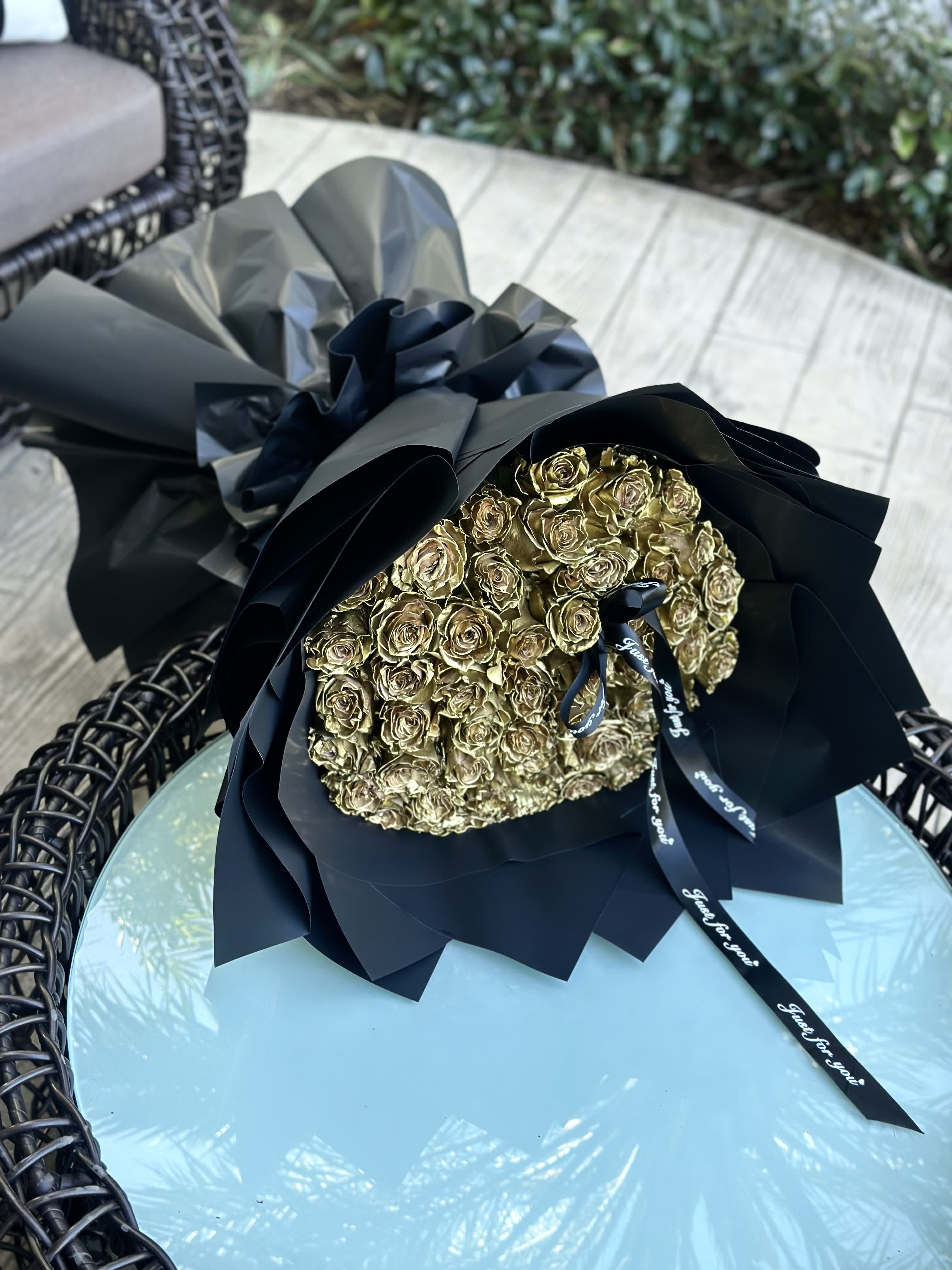Bouquet of Golden 50 Roses - A stunning arrangement of golden roses nestled in sleek black packaging adorned with delicate ribbons, exuding an aura of timeless elegance and sophistication.