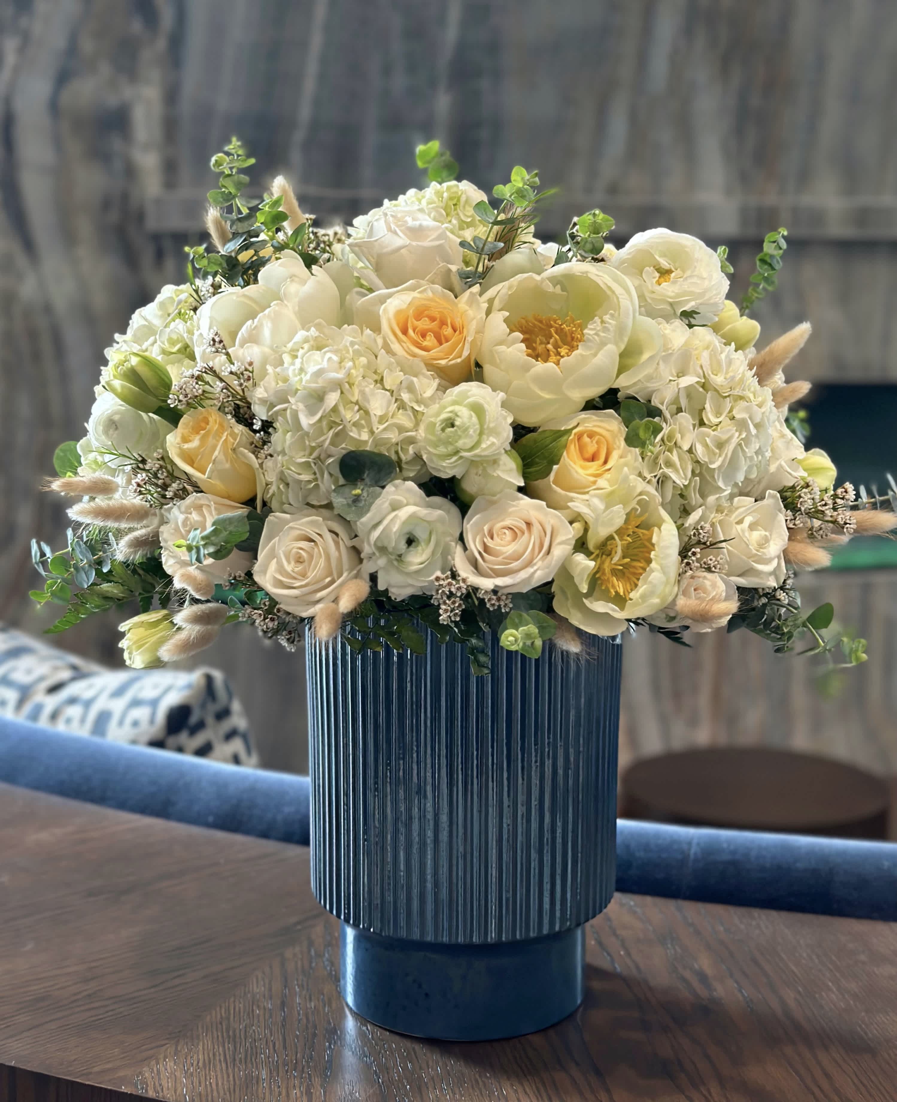 Flower Melody - From an exquisite vase flows streams of beauty: delicate peonies, sumptuous roses, and graceful ranunculuses. Their petals, like an artist's brushstrokes, dance in harmony, creating pictures of incredible elegance and refinement. This bouquet becomes an embodiment of springtime magic, filling the space with a gentle fragrance and joy, as if inviting into a world of dreams and beauty.
