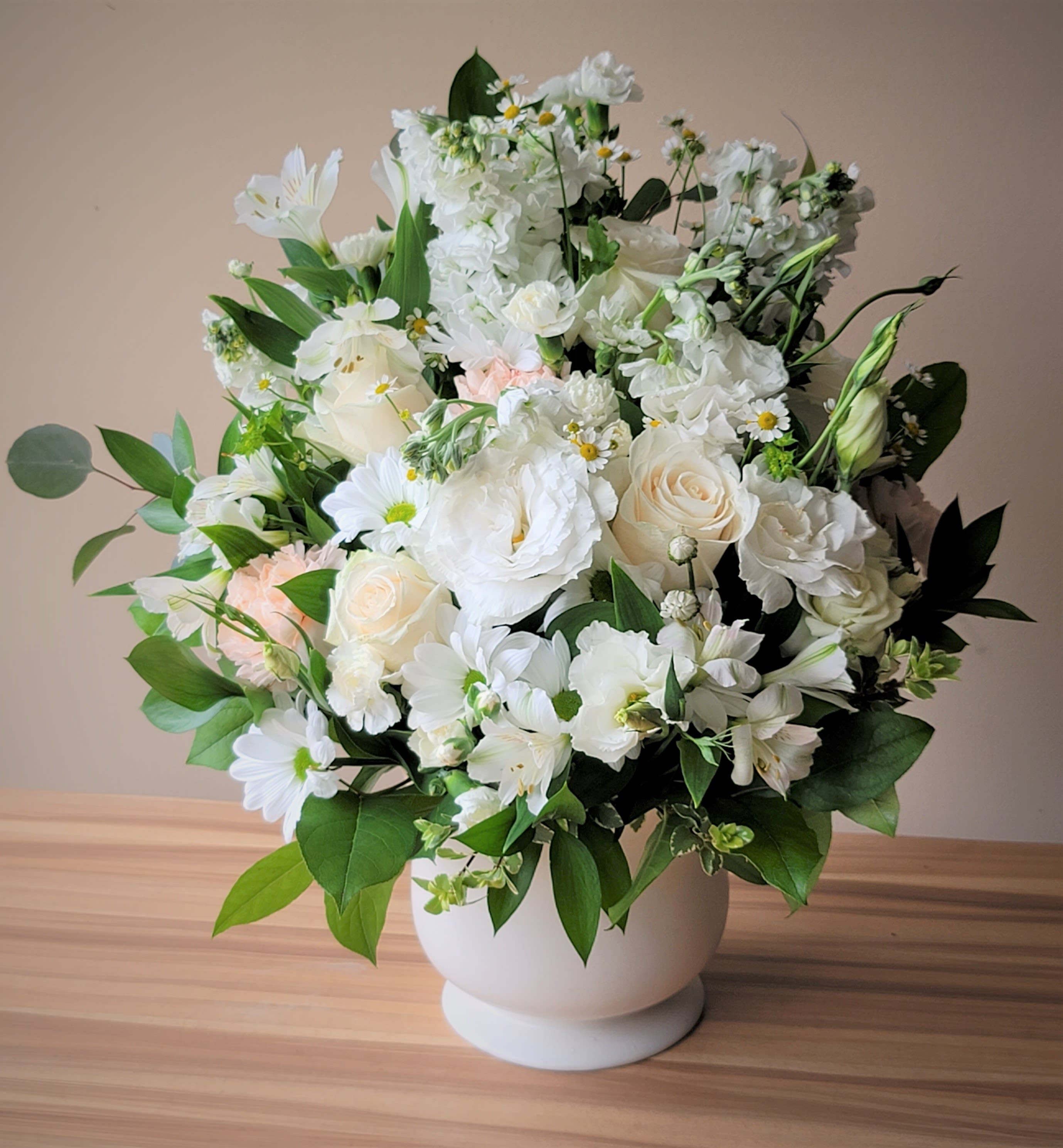 Pure Blessings Tribute - Pure Blessings Tribute bouquet is the perfect way to show your support by sending a classic arrangement of white bloom, lush greens, and seasonal accents.  This delicate arrangement comes crafted with an elegant mix of lilies, roses, and hydrangeas to send messages of comfort with charm and grace.  Approximately 24&quot;H x 18&quot;W.  