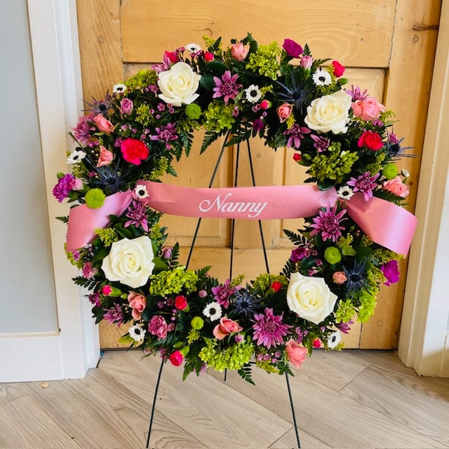 Fresh Flower Wreath  - Pictures are examples only. Prices are our starting price and may not reflect the pricing of sample pictures. Orders placed online will be filled as florist's choice to the price point selected. Optional Banners and stands are available at an additional cost. Please call or visit us to place a specific order.