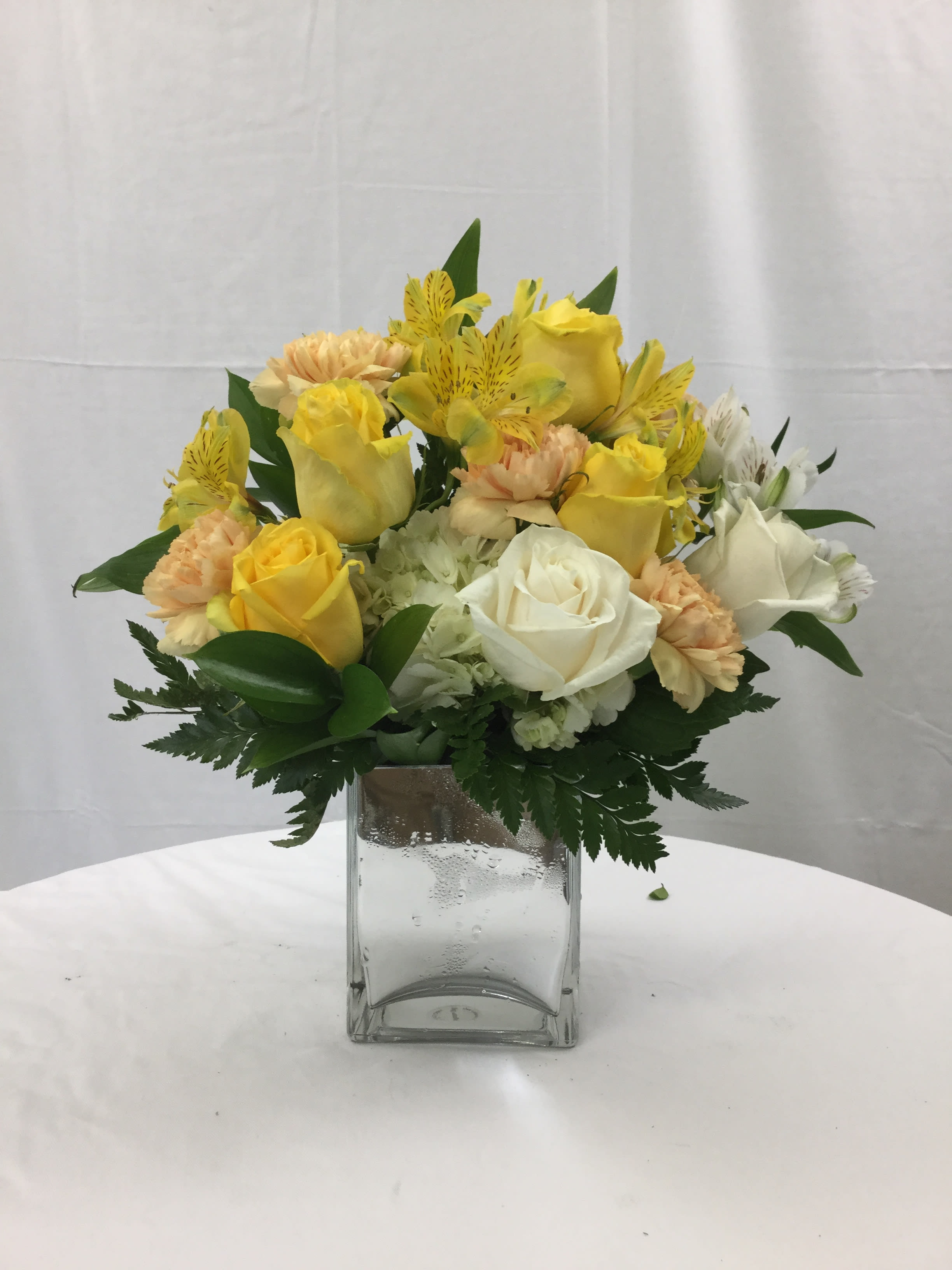 Pastel of Elegance Cube Bouquet - This stunning beauty is full of fresh pastel blooms and will light up the room with love or friendship. Hand-crafted and designed in an elegant cube vase. Makes for a wonderful gift during the Spring and Summer Seasons. 