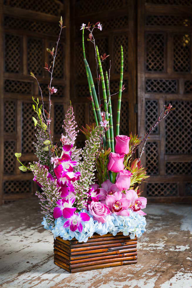 Purple Haze - Cymbidium Blooms, roses, dendrobium orchids, heather , equisitum bring this design to life.