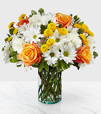 Sweet Moments Bouquet - Through a collection of bold hues, gorgeous flowers, and fresh scents, this bouquet blossoms with beauty in any room that its placed. An array of orange roses, variegated pittosporum, and white daisy pompons come together in a cylindrical glass vase to make the perfect gift for a loved one near or far. 