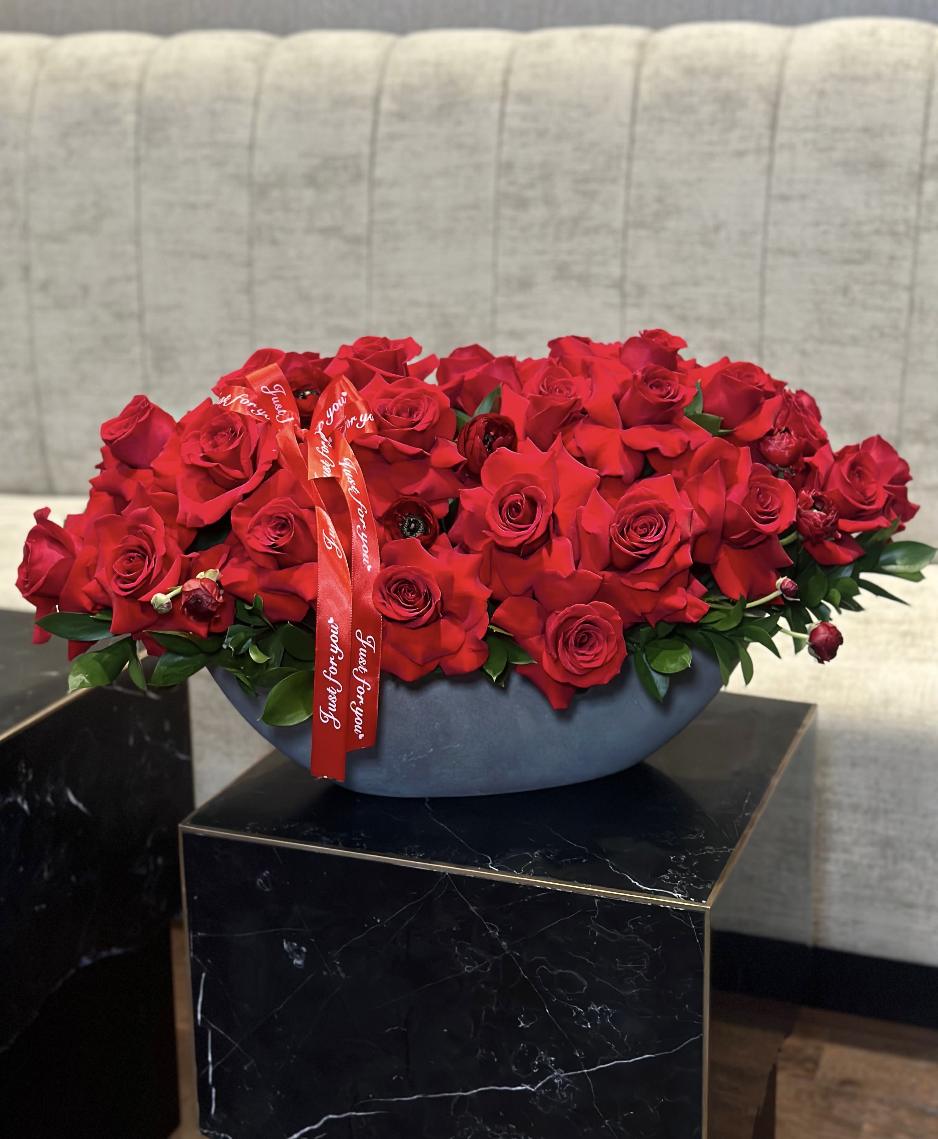Classic Vase with Red Roses &amp; Ranunculus - A stunning vase adorned with vibrant red roses and ranunculuses exudes passion and beauty. The deep crimson hue of the roses, coupled with the delicate petals of the ranunculuses, creates a striking contrast that captivates the senses. The rich, velvety texture of the roses complements the intricate layers of the ranunculus blooms, forming an exquisite display of natural elegance. Each flower, with its unique charm and allure, adds depth and dimension to the arrangement, evoking feelings of romance and sophistication. Whether as a centerpiece for a special occasion or a luxurious gift, this vase with red roses and ranunculuses is sure to leave a lasting impression of love and admiration.