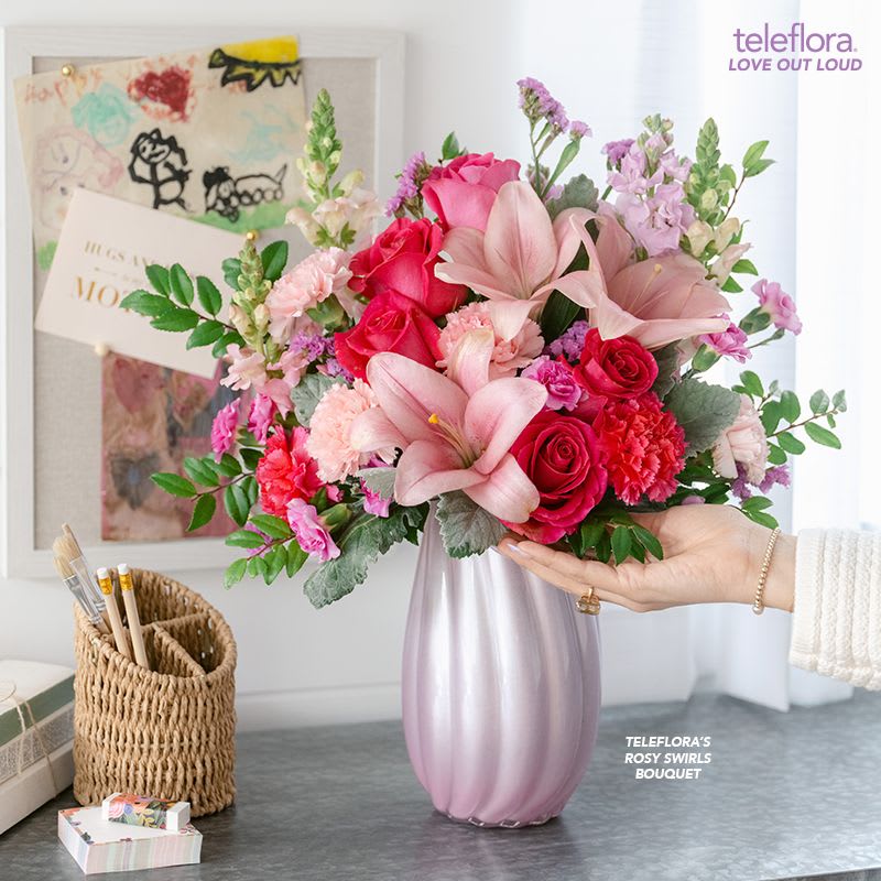 Rosy Swirls Bouquet - Capture Mom's heart with our pearlescent Teleflora's Rosy Swirls vase, radiating elegance and charm, paired with a bouquet of pink roses and lavender blooms, a delightful Mother's Day surprise she'll cherish.
