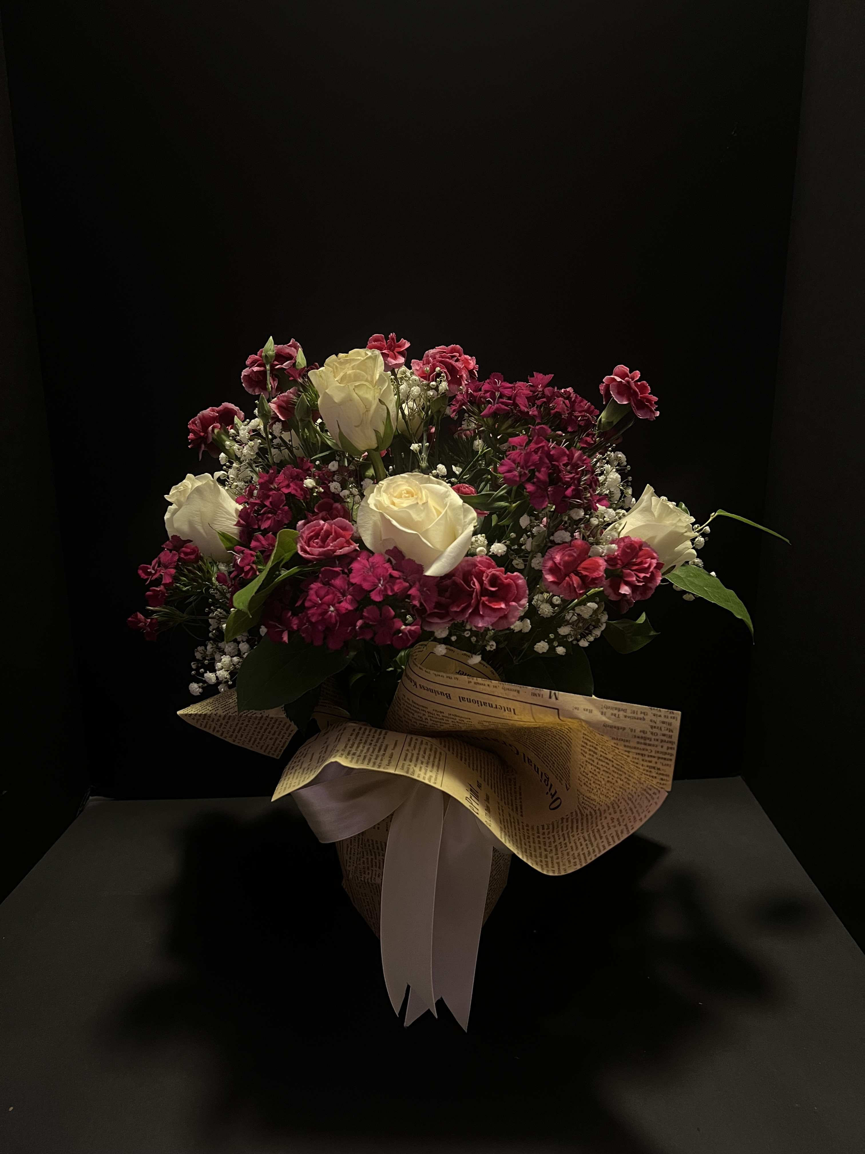 Serenity Blooms - Tranquil whites roses, hot pink and soft pink carnations that mingle together in this arrangement, bringing a sense of calm and serenity  Substitution Policy:  At Vision Bloomz, we strive to deliver each floral arrangement exactly as pictured on our website. However, due to seasonal availability and the unique nature of flowers, there may be instances where substitutions are necessary to ensure the freshest blooms and timely delivery.  In the event that a specific flower or container shown in the arrangement is not available, we will make every effort to replace it with a comparable alternative of equal or greater value. Our skilled florists will carefully select blooms that maintain the overall style, color scheme, and aesthetic of the original design.  Please note that while substitutions may occasionally be necessary, we guarantee that the quality and integrity of your arrangement will never be compromised. Rest assured, your recipient will still receive a stunning floral creation that reflects your thoughtful gesture and the essence of the occasion.  If you have any preferences or special requests regarding substitutions, please feel free to include them in the &quot;Special Instructions&quot; section during checkout, and we will do our best to accommodate your preferences.  Thank you for choosing Vision Bloomz for your floral needs. We appreciate your trust and look forward to exceeding your expectations with every arrangement we create