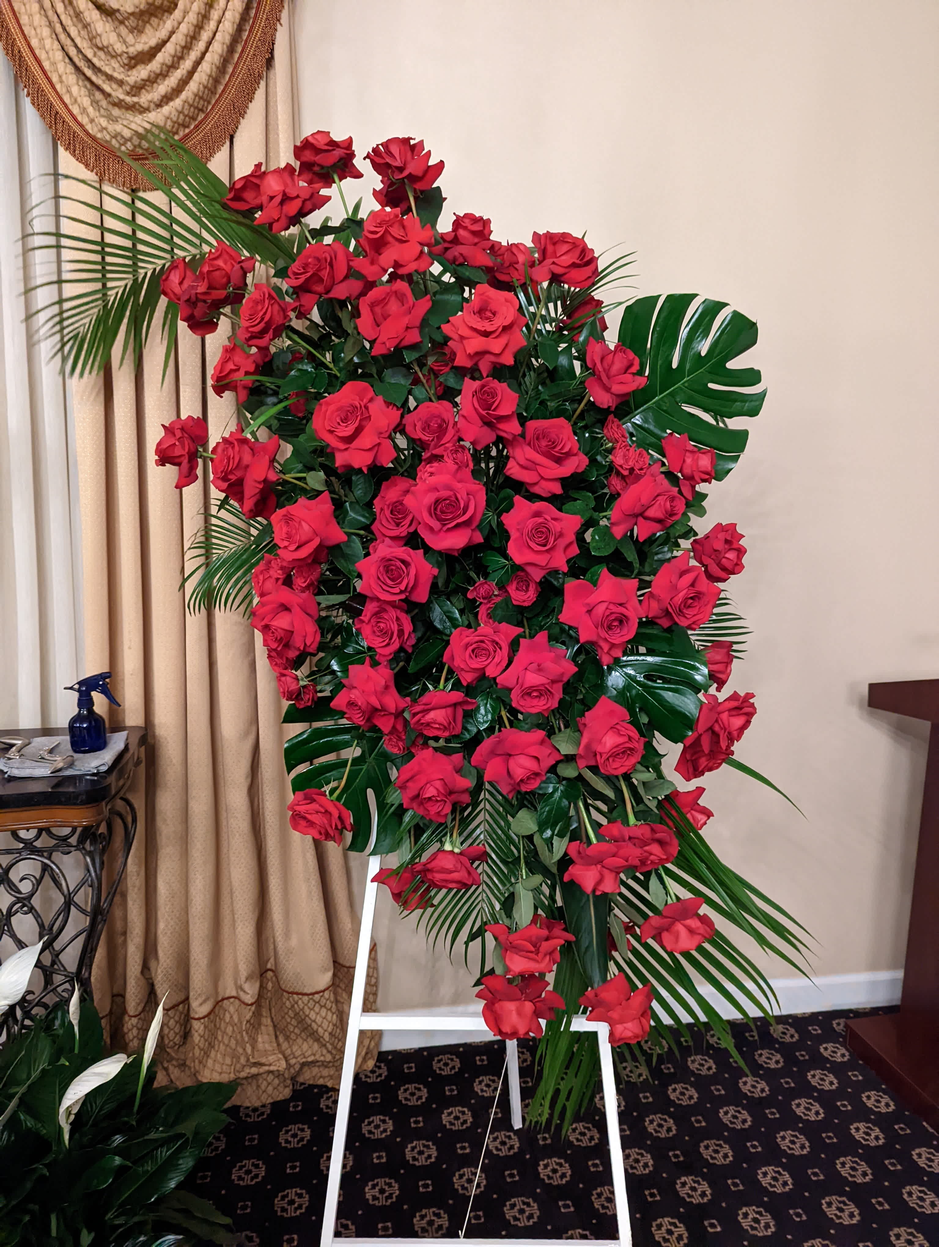 Stunning Red Rose Funeral Spray Stunning Red Rose Funeral Spray - Rich and luxurious, and over 6 feet tall, this spray is the perfect way to say goodbye!