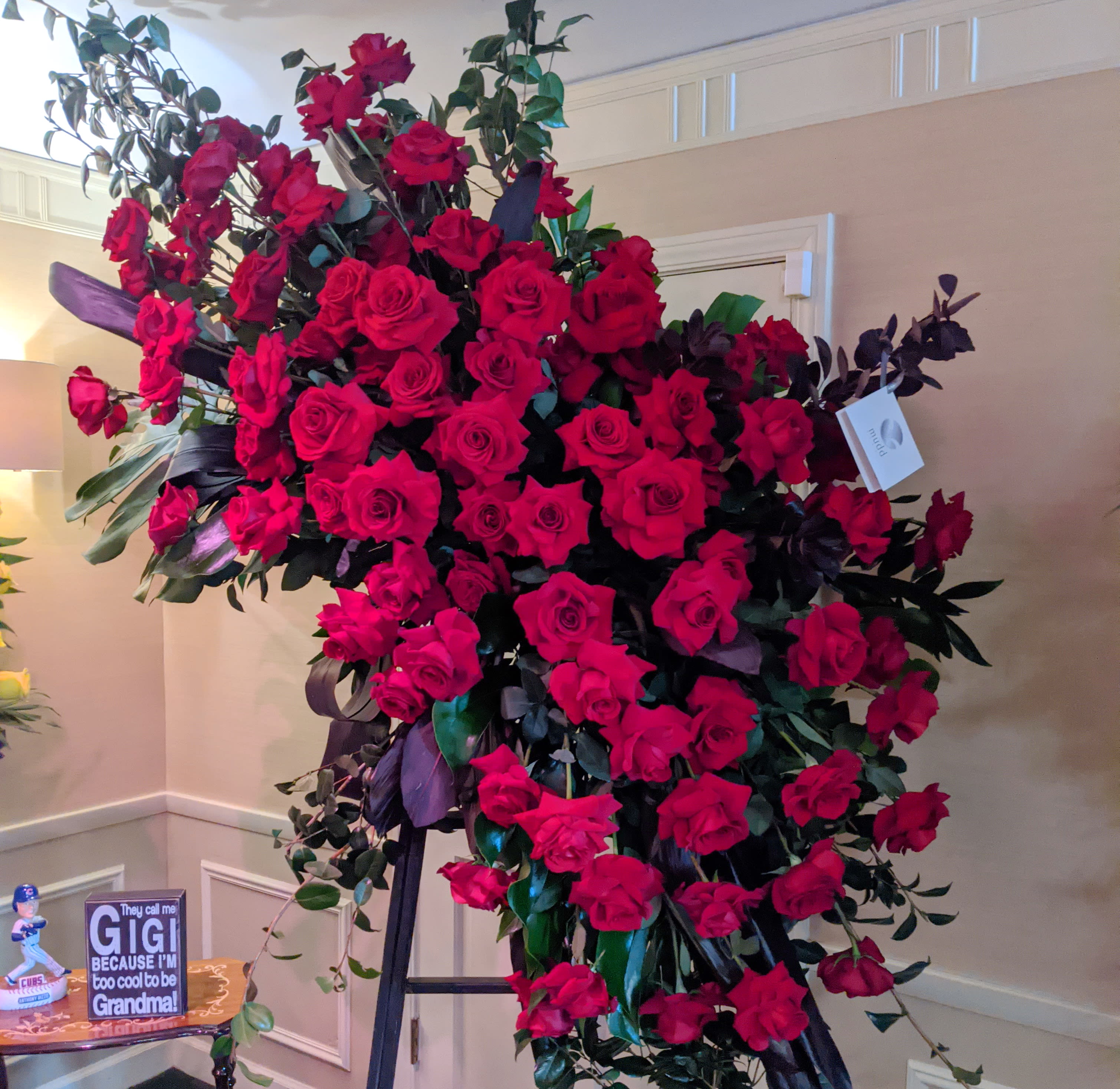 Huge Red Rose Sympathy Easel Huge Red Rose Sympathy Easel - This is a wonderful way to say goodbye to someone special. The red rose easel spray is 7-8 feet tall and 3-4 feet wide. This asymmetrical design features camelia and other tropical foliages.