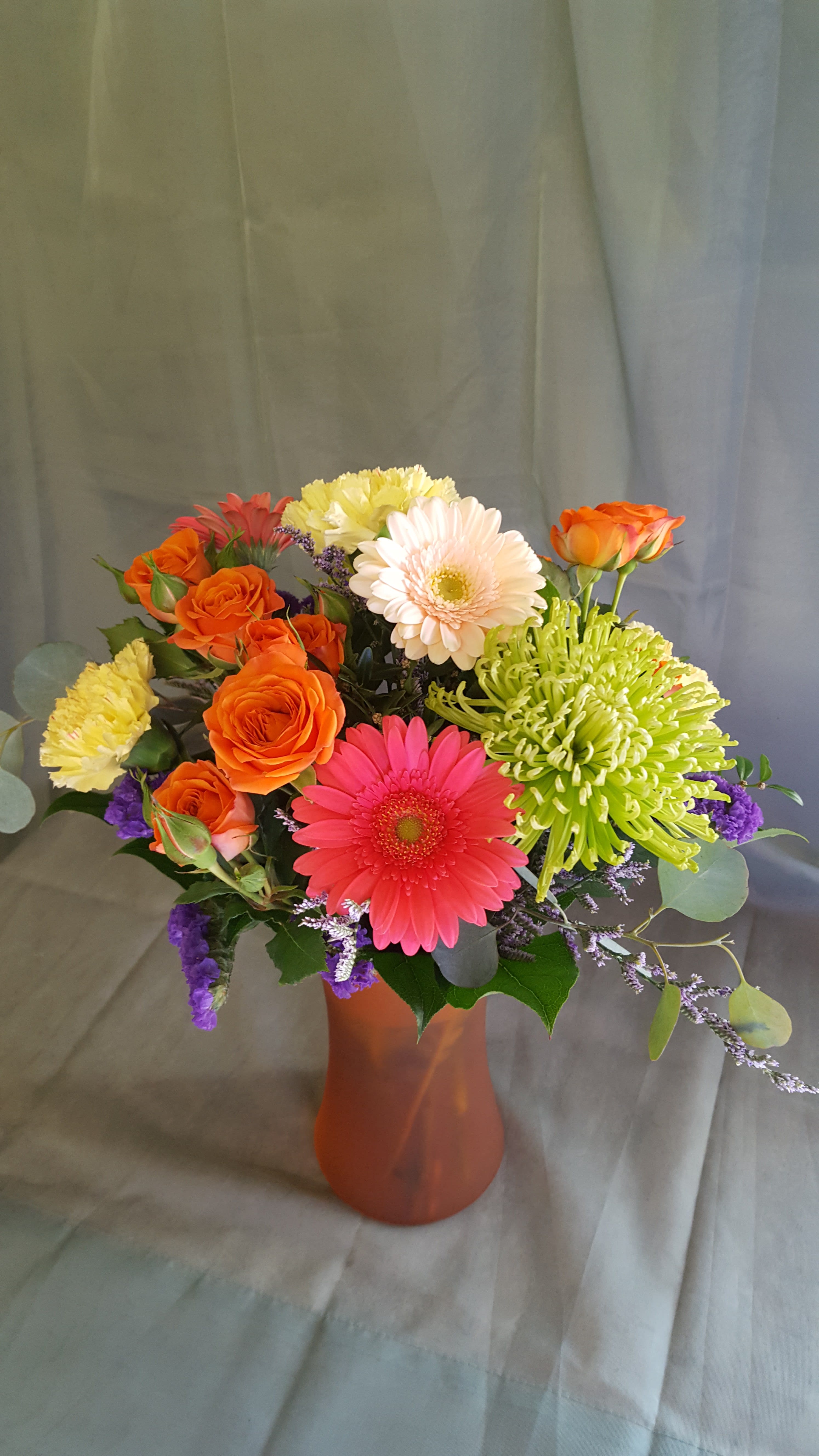 Color me Bright Color me Bright - Bright and cheery vase of green fugi mums, spray roses, gerbera daisies, carnations, eucalyptose and statice and caspia filler flowers