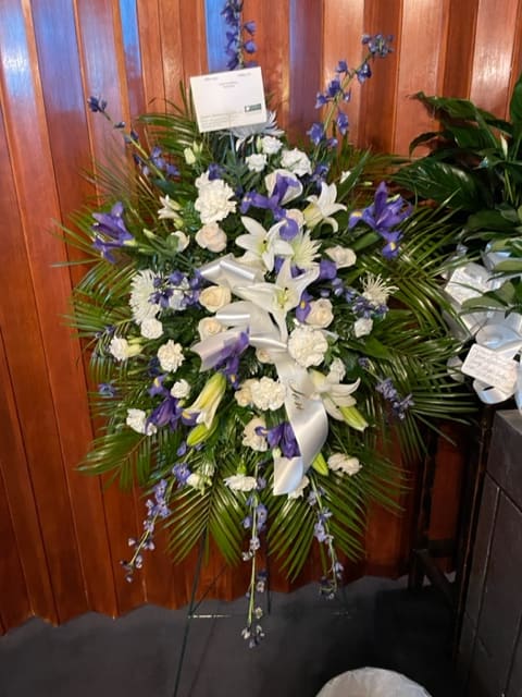 White &amp; Blue Standing Spray - Standing spray with blue delphinium, white lilies, white/cream roses, white carnations, and blue iris