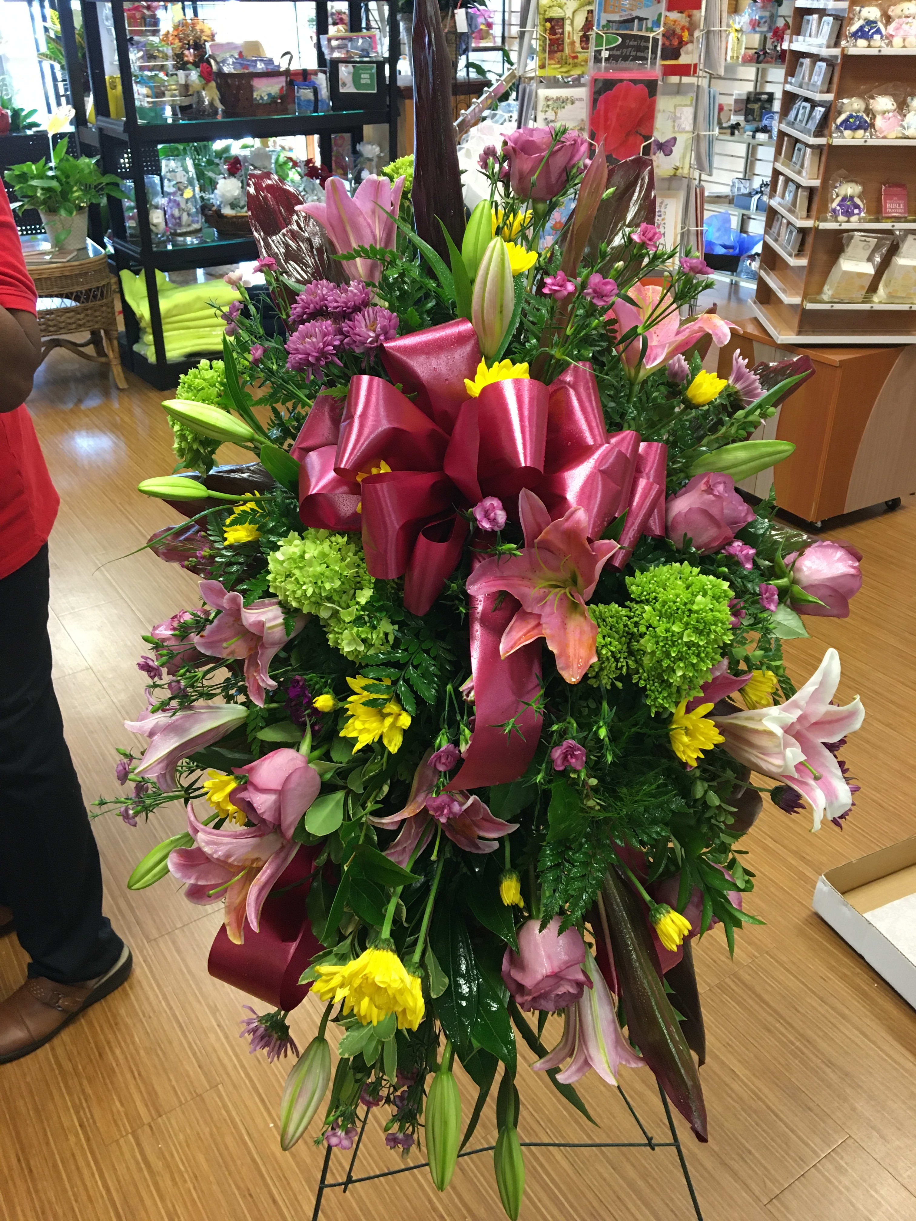 Pink and Green Standing Spray - Standing spray with pink lilies, green hydrangea, pink roses, yellow daisies, and  purple mums