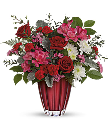 Sophisicated Love Bouquet - Sleek and sophisticated, this stunning Valentine's Day surprise features lush red and pink blooms presented in a beautiful vase of European glass with ombre metallic finish. This sophisticated bouquet includes red roses, miniature red carnations, pink alstroemeria, white cushion spray chrysanthemums, pink sinuata statice, leatherleaf fern, parvifolia eucalyptus, lemon leaf, and dusty miller. Delivered in a Sophisticated Love vase.