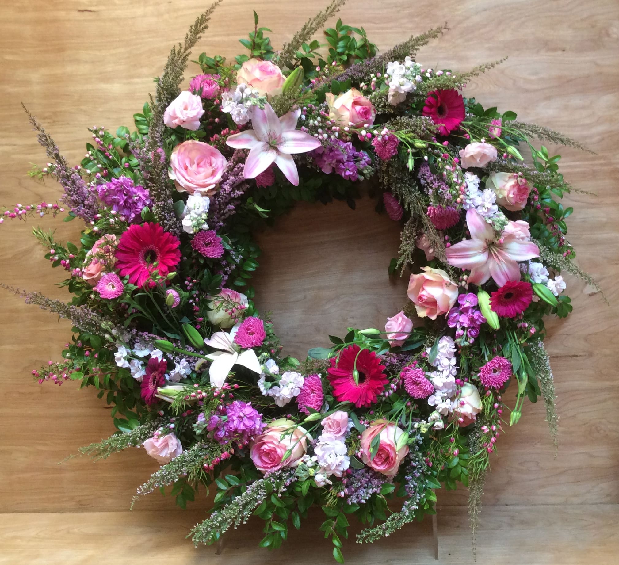 Shades of pink wreath Shades of pink wreath - Vivid hues of pinks and purple are a tribute to her spirit and beauty, an expressive reminder of so many cherished memories and unforgettable times. Beautiful fresh seasonal shades of pink flowers fill this lovely wreath.