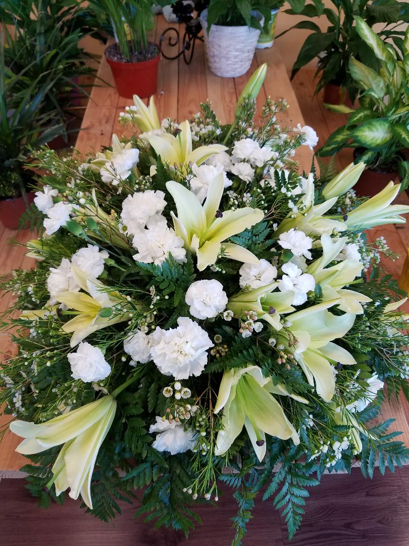 CASKET SPRAY (ROSES, CARNATIONS, LILIES, AND OTHER FILLERS) CASKET SPRAY (ROSES, CARNATIONS, LILIES, AND OTHER FILLERS) - IT MEASURES ABOUT 36 INCHES LONG AND ABOUT 26 INCHES WIDE