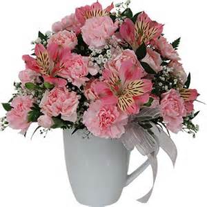 Mug of Love Mug of Love - Light/fushia pink artificial/fresh alstromeria and pink carnations with white baby's breathe, greenery in a white ceramic mug with sheer ribbon added. Such a sweet gift for any occasion!