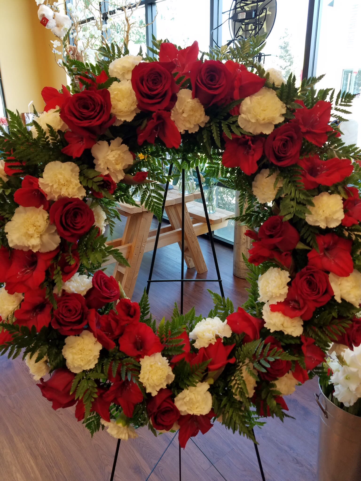 Red peace wreath Red peace wreath - Red gladiolas, red roses, white carnations standard size is 18 inch wreath Deluxe is 22 inch wreath Premium is 24 inch wreath