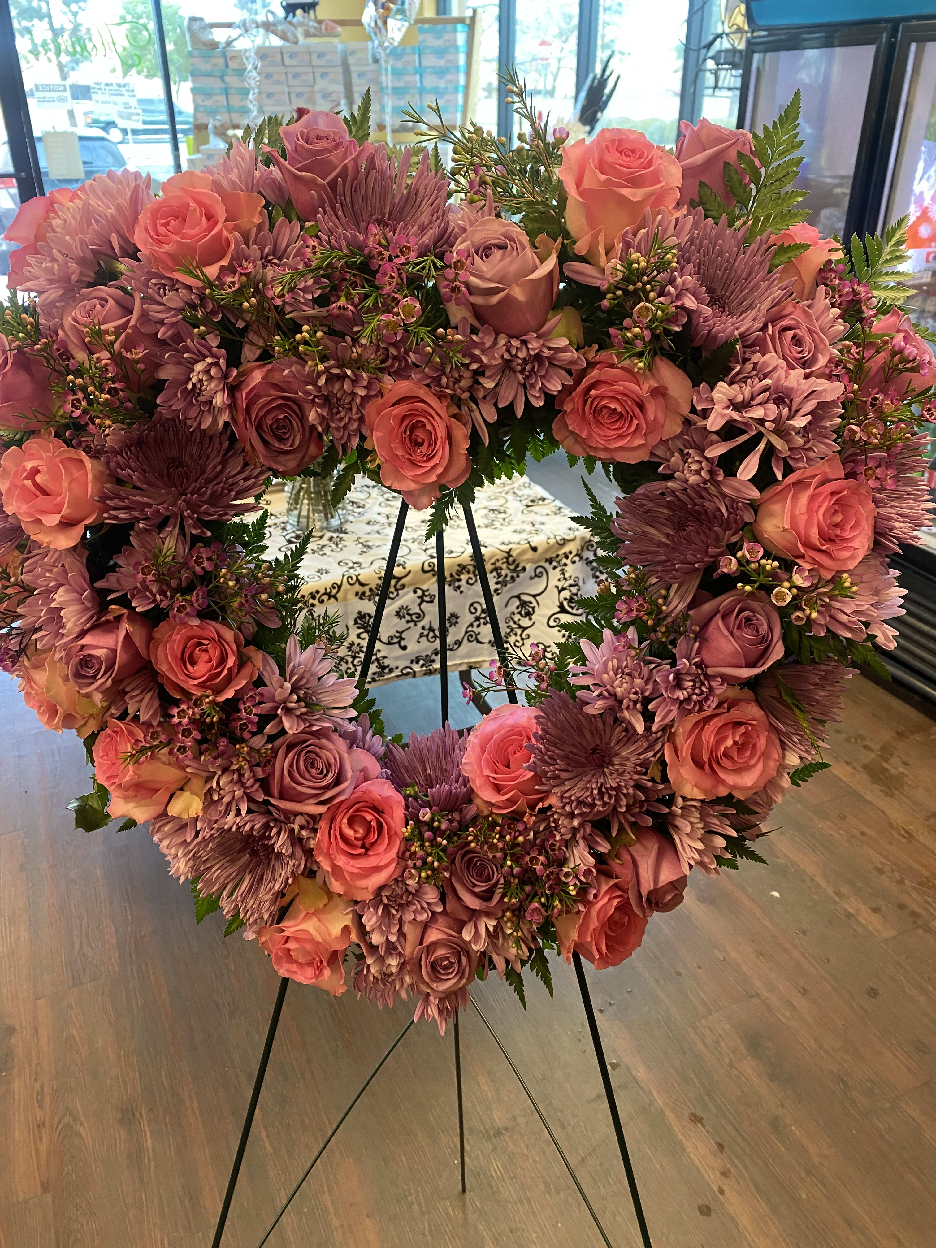 Heart Standing Spray (Purple and Pink Flowers) Heart Heart Standing Spray (Purple and Pink Flowers) Heart - Designer choice Pink and Purple Roses will be included with Spider Mums and Cushion And Purple Wax Standard price is an 18 inch heart with 25 roses and other flowers Deluxe price is a 24 inch heart (it includes 36 roses and other flowers) Premium price is also a 24 inch heart but with 46 roses