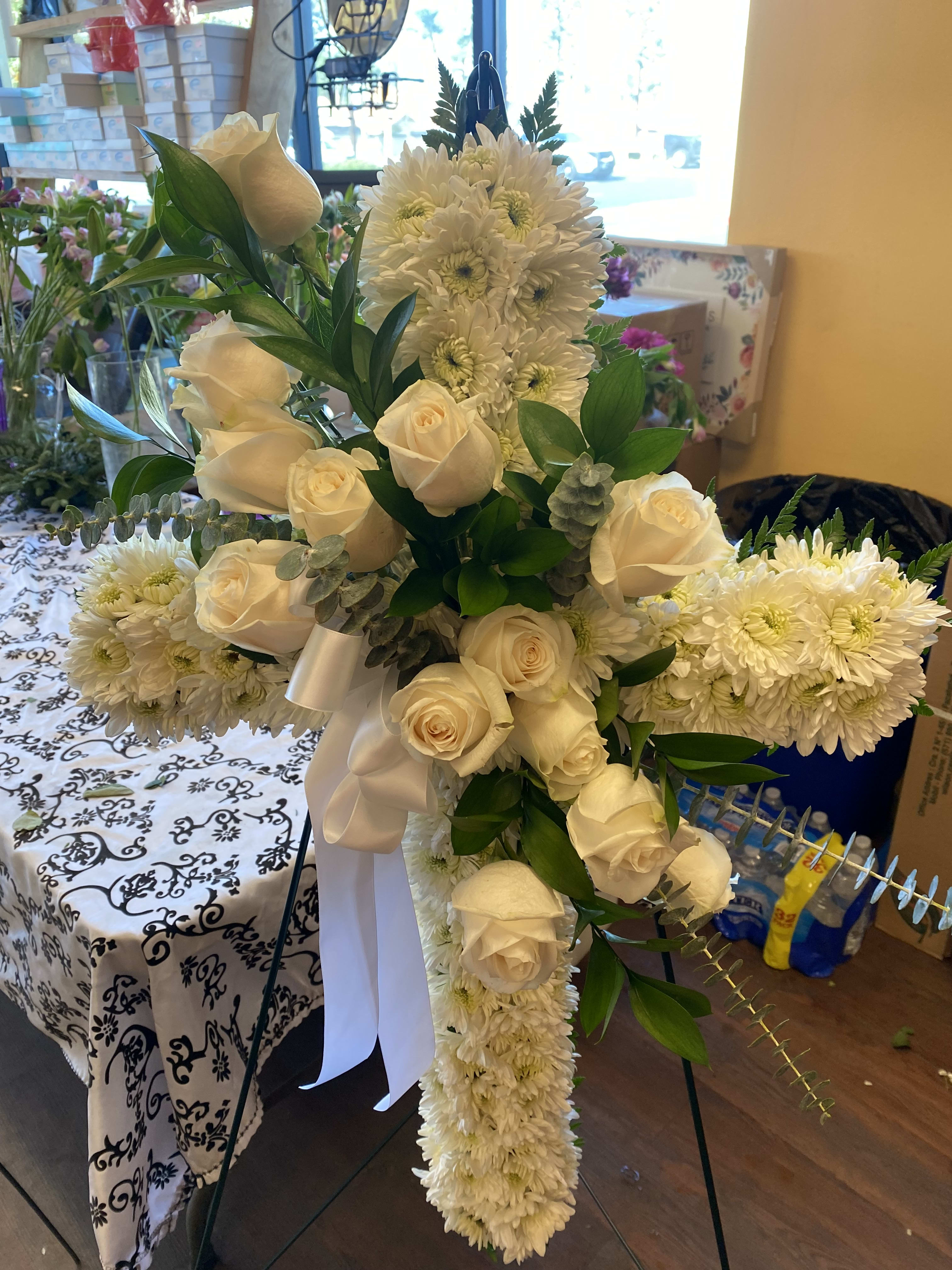 WHITE CROSS WHITE CROSS - A CROSS WITH WHITE ROSES IN THE CENTER WITH GREENARY AND WHITE CUSHION ALL AROUND REGULAR PRICE IS A 20 INCH CROSS DELUXE PRICE IS A 30 INCH CROSS PREMIUM PRICE IS A 36 INCH CROSS