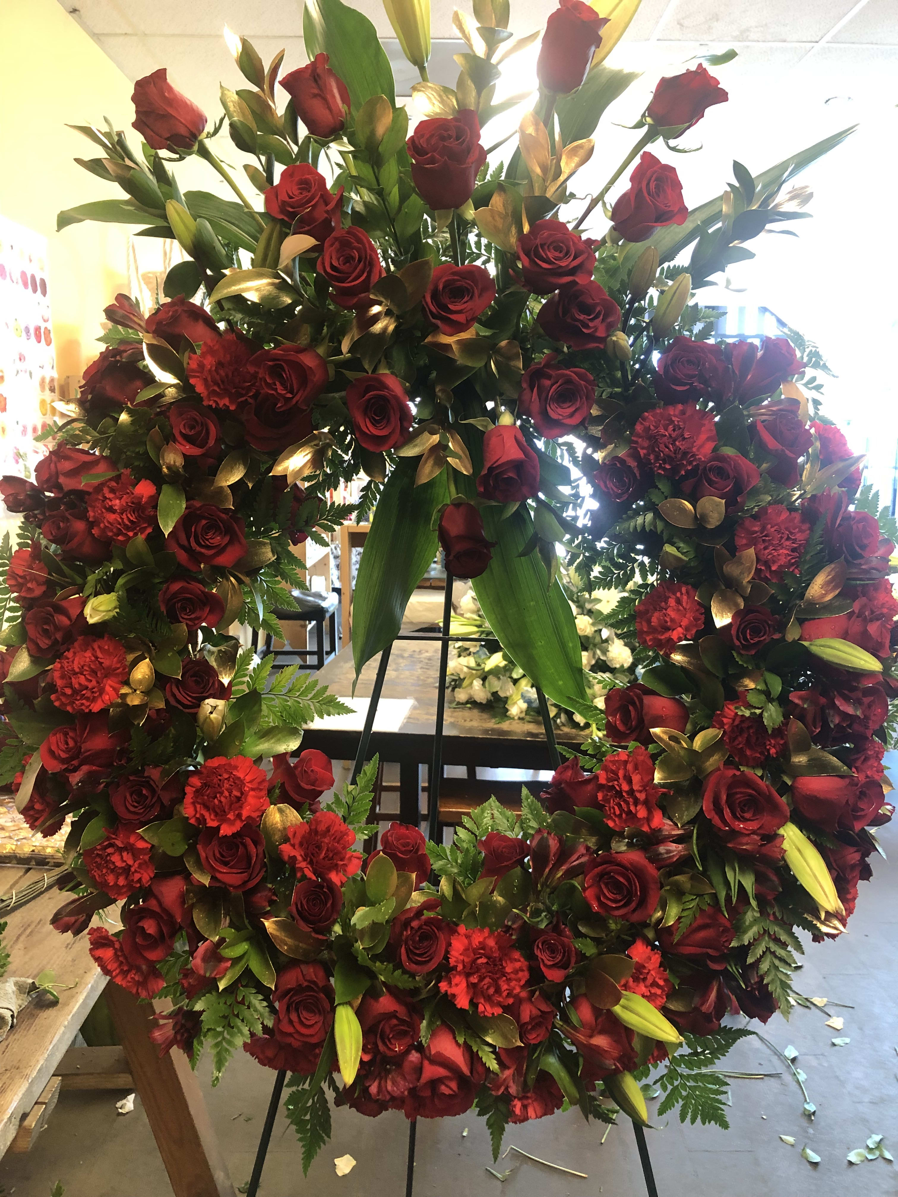 MY HEART IS BROKEN WREATH - 50 Red Roses, Red Alstroemeria, unopened white lilies, and red carnations and gold leaves.   See video of this Spray on my Instagram account Aleea Flowers   THIS IS A 24 INCH WREATH