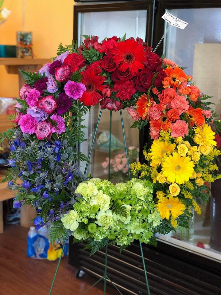 Rainbow Wreath Rainbow Wreath - Mixture of Roses, Gerber Daisies, carnations, and other fillers to complete this look Standard size is 18 inches Deluxe size is 22 inches Premium size is 24 inches