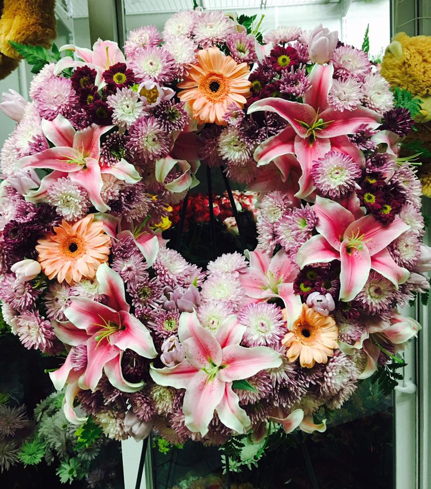 Standing Wreath. The Photo Shows A Deluxe Size - Please call (347) 492 - 5777 for variations and options. Available any size any price any flowers and can be done as a hand rappped bouquet or basket.