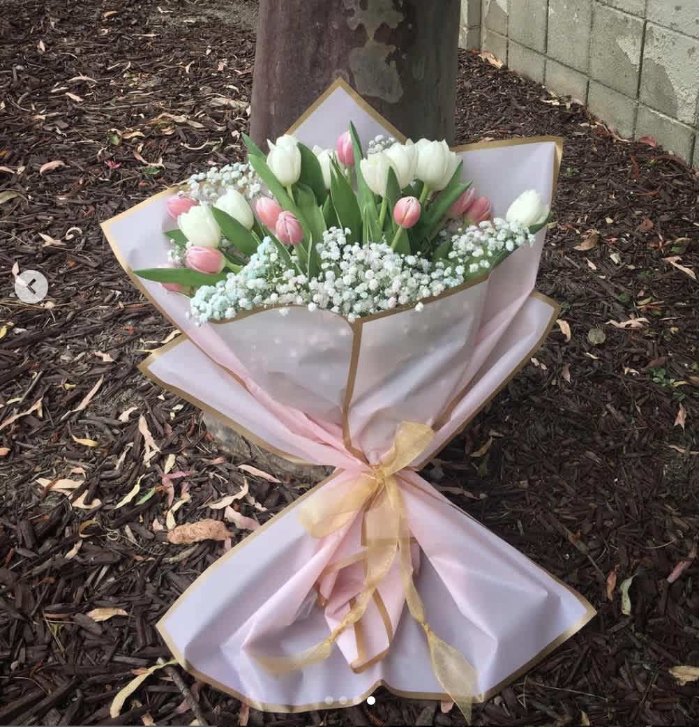 Spring Seranade - Beautiful bouquet of tulips and baby breathe flowers wrapped in pink paper. 