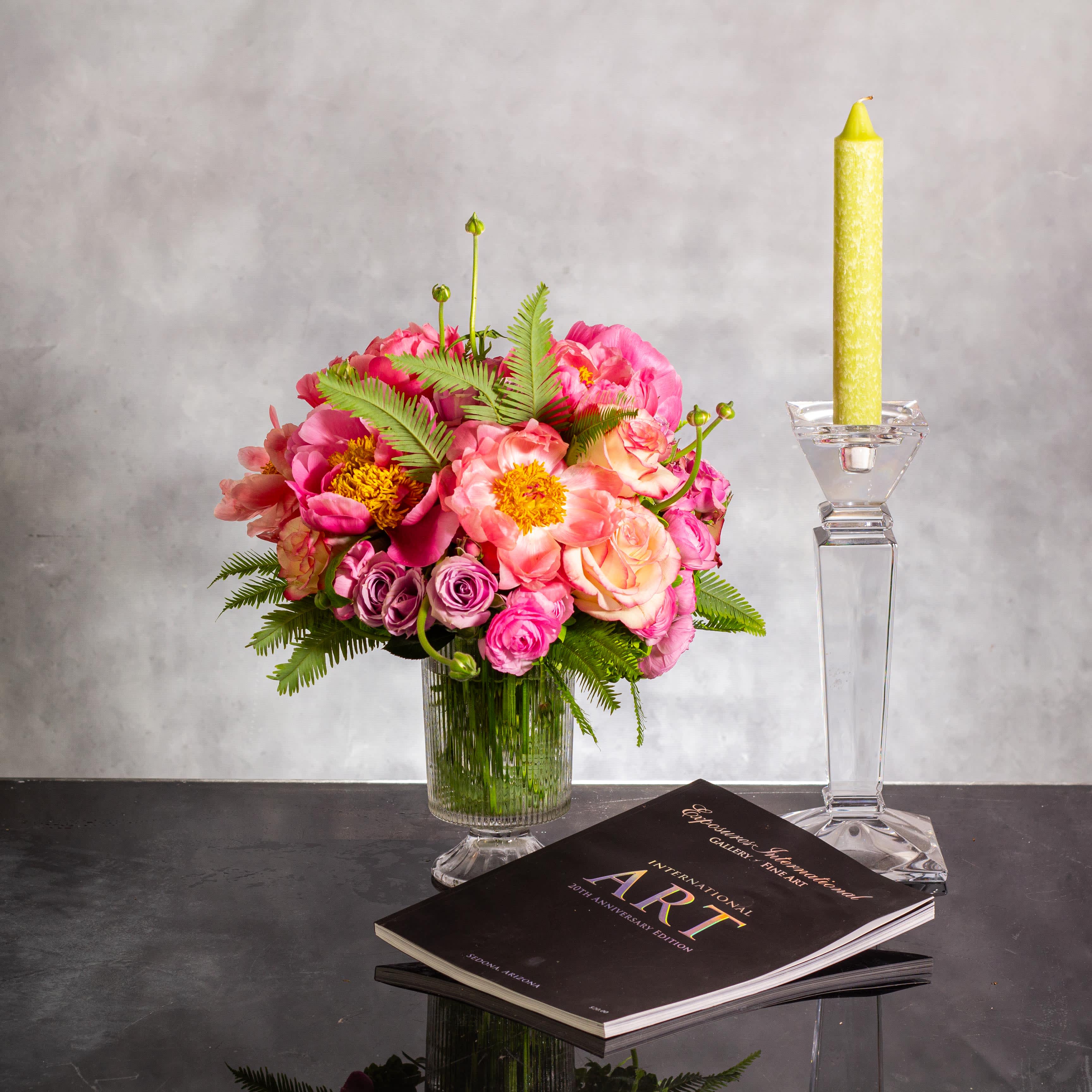 Timeless Opulence - Delight in the exquisite artistry of this Beverly Hills Florist creation, available for same-day delivery. Vintage peonies and light pink orchids come together in a harmonious blend of timeless beauty, transcending eras with their enchanting allure. Housed in a crystal pedestal vase, standing approximately 12 inches tall and 8 inches wide, this arrangement marries the classic charm of peonies with the contemporary elegance of orchids. The transparency of the glass accentuates the delicate nature of the blooms, creating an embodiment of enduring sophistication and grace.